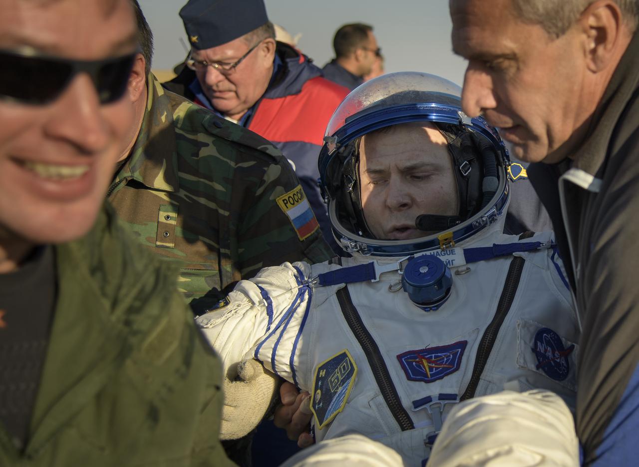 Expedition 60 crewmembers Nick Hague of NASA is helped out of the Soyuz MS-12 spacecraft just minutes after he and fellow crew mate Expedition 60 cosmonaut Alexey Ovchinin of Roscosmos, and visiting astronaut Hazzaa Ali Almansoori of the United Arab Emirates, landed in a remote area near the town of Zhezkazgan, Kazakhstan on Thursday, Oct. 3, 2019. Hague and Ovchinin are returning after 203 days in space where they served as members of the Expedition 59 and 60 crews onboard the International Space Station. Almansoori logged 8 days in space during his first flight as an astronaut. Photo Credit: (NASA/Bill Ingalls)