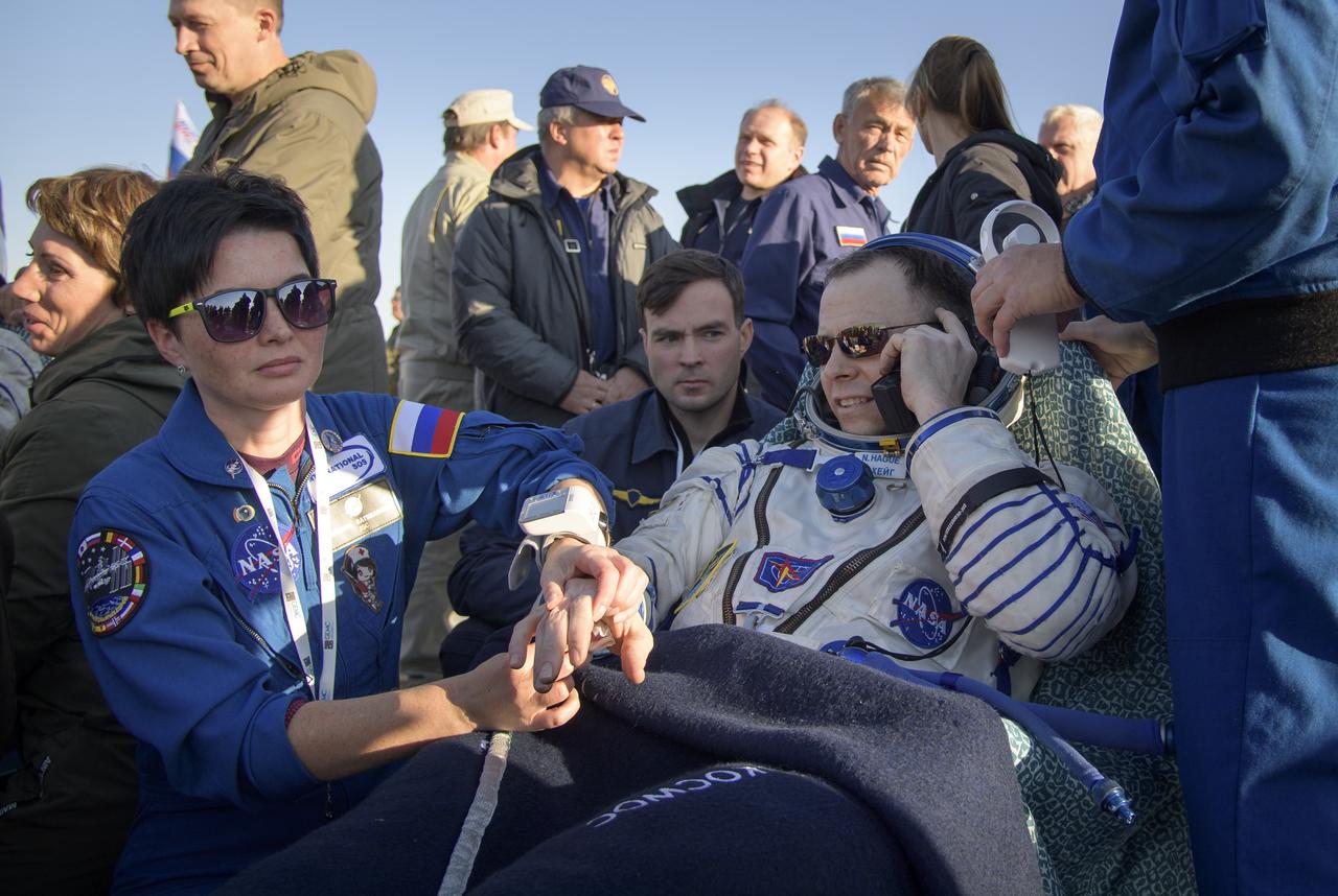 Expedition 60 crewmember Nick Hague of NASA is seen outside the Soyuz MS-12 spacecraft after he landed with fellow crewmember Alexey Ovchinin of Roscosmos and visiting astronaut Hazzaa Ali Almansoori of the United Arab Emirates in a remote area near the town of Zhezkazgan, Kazakhstan on Thursday, Oct. 3, 2019. Hague and Ovchinin are returning after 203 days in space where they served as members of the Expedition 59 and 60 crews onboard the International Space Station. Almansoori logged 8 days in space during his first flight as an astronaut. Photo Credit: (NASA/Bill Ingalls)