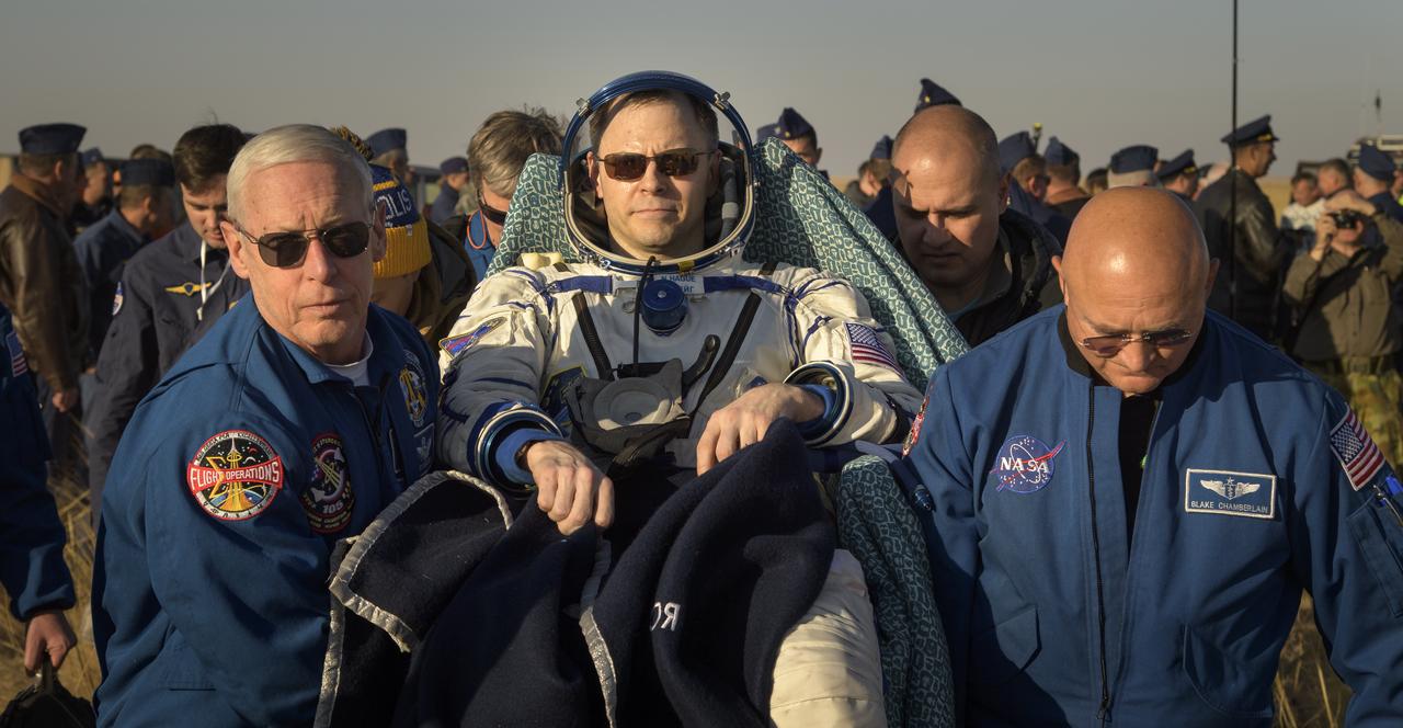 Expedition 60 crewmember Nick Hague of NASA is carried to a medical tent by NASA Chief Astronaut Pat Forrester, left, and NASA Flight Surgeon Blake Chamberlain, right, after he and fellow Expedition 60 crewmember Alexey Ovchinin of Roscosmos and visiting astronaut Hazzaa Ali Almansoori of the United Arab Emirates landed in their Soyuz MS-12 spacecraft near the town of Zhezkazgan, Kazakhstan on Thursday, Oct. 3, 2019. Hague and Ovchinin are returning after 203 days in space where they served as members of the Expedition 59 and 60 crews onboard the International Space Station. Almansoori logged 8 days in space during his first flight as an astronaut. Photo Credit: (NASA/Bill Ingalls)