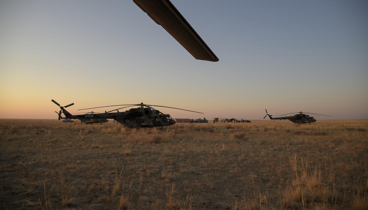 Crews work around the Soyuz MS-12 spacecraft landing site after the capsule landed with Expedition 60 crew members Nick Hague of NASA and Alexey Ovchinin of Roscosmos, along with visiting astronaut Hazzaa Ali Almansoori of the United Arab Emirates in a remote area near the town of Zhezkazgan, Kazakhstan, Thursday, Oct. 3, 2019. Hague and Ovchinin are returning after 203 days in space where they served as members of the Expedition 59 and 60 crews onboard the International Space Station. Almansoori logged 8 days in space during his first flight as an astronaut. Photo Credit: (NASA/Bill Ingalls)