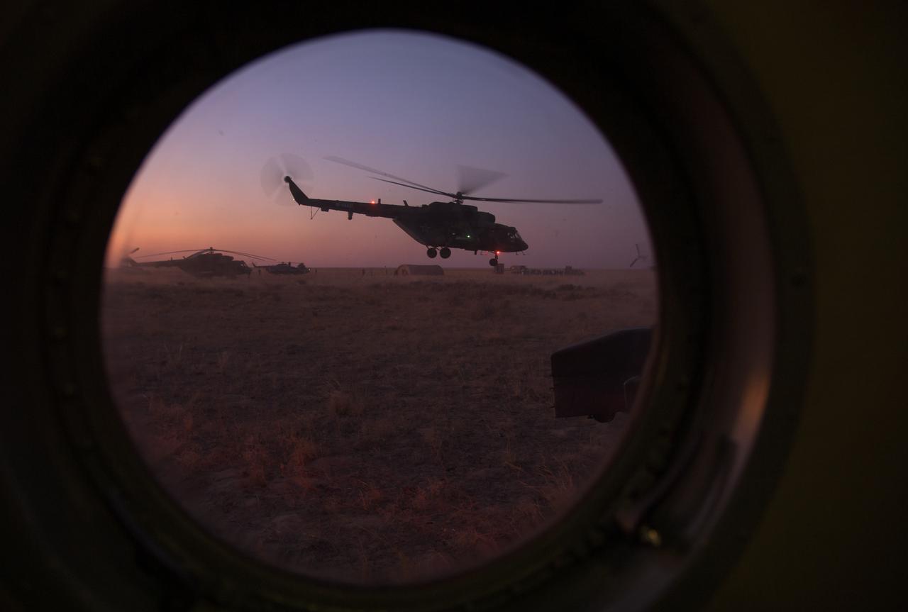 A Russian MI-8 helicopter departs the Soyuz MS-12 spacecraft landing site after the capsule landed with Expedition 60 crew members Nick Hague of NASA and Alexey Ovchinin of Roscosmos, along with visiting astronaut Hazzaa Ali Almansoori of the United Arab Emirates in a remote area near the town of Zhezkazgan, Kazakhstan, Thursday, Oct. 3, 2019. Hague and Ovchinin are returning after 203 days in space where they served as members of the Expedition 59 and 60 crews onboard the International Space Station. Almansoori logged 8 days in space during his first flight as an astronaut. Photo Credit: (NASA/Bill Ingalls)