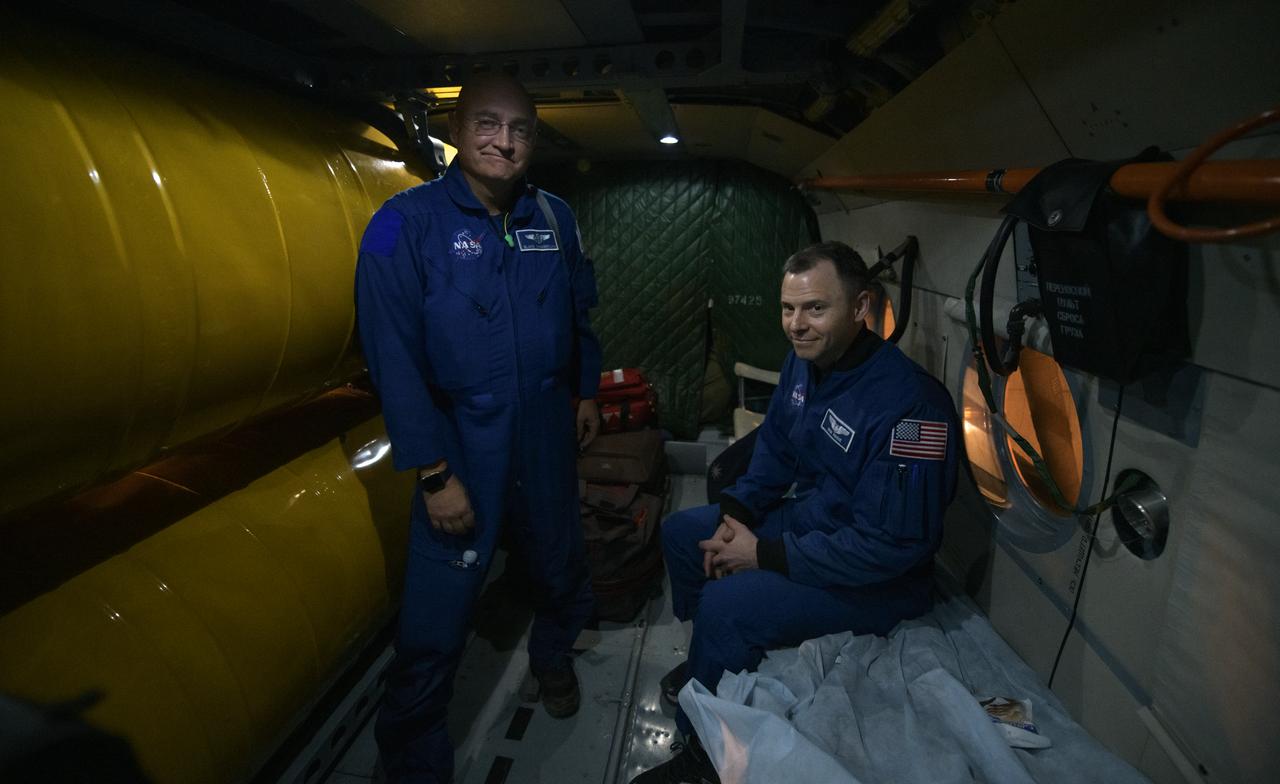 Expedition 60 NASA astronaut Nick Hague, left, and NASA Flight Surgeon Blake Chamberlain wait inside at Russian MI-8 helicopter after arriving at the Karaganda Airport in Kazakhstan from a remote area near the town of Zhezkazgan, Kazakhstan on Thursday, Oct. 3, 2019. Hague and fellow Expedition 60 crewmember Alexey Ovchinin are returning after 203 days in space where they served as members of the Expedition 59 and 60 crews onboard the International Space Station. Visiting astronaut Hazzaa Ali Almansoori of the United Arab Emirates also returned with the crew after logging 8 days in space during his first flight as an astronaut. Photo Credit: (NASA/Bill Ingalls)