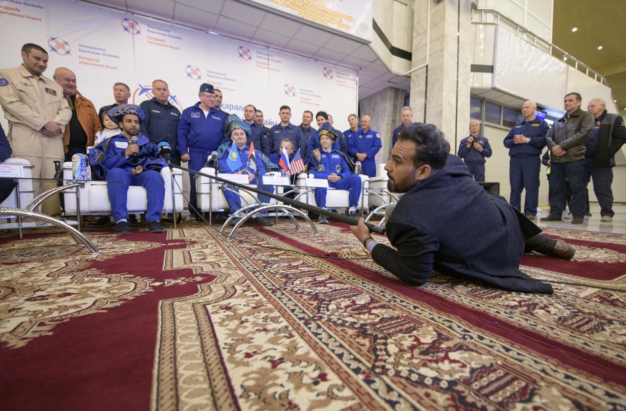 Visiting astronaut Hazzaa Ali Almansoori of the United Arab Emirates, left, and Expedition 60 crewmembers Alexey Ovchinin of Roscosmos and Nick Hague of NASA, right, attend a Karaganda Airport welcome ceremony in Kazakhstan on Thursday, Oct. 3, 2019. Hague and Ovchinin are returning after 203 days in space where they served as members of the Expedition 59 and 60 crews onboard the International Space Station. Almansoori logged 8 days in space during his first flight as an astronaut. Photo Credit: (NASA/Bill Ingalls)