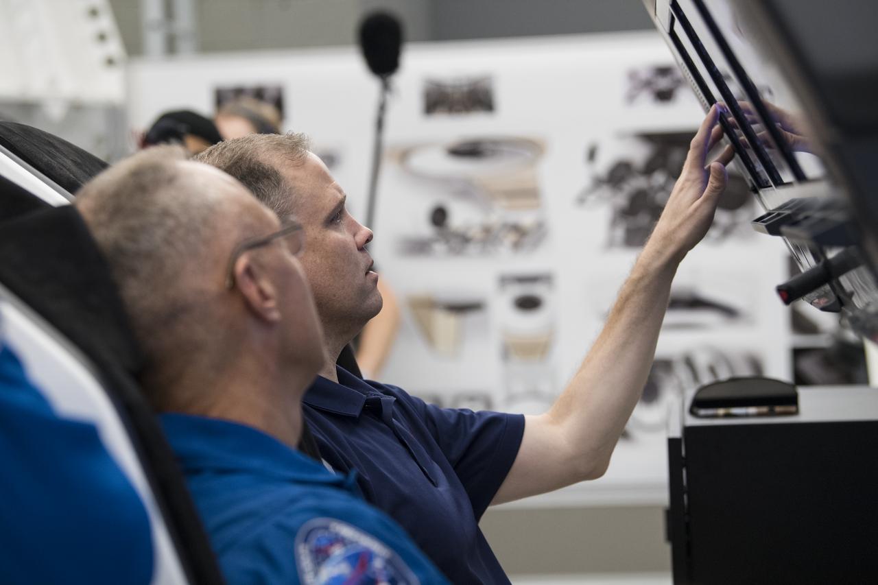 NASA Administrator Jim Bridenstine, right, participates in a crew Dragon flight simulation with NASA astronauts Doug Hurley, who will be flying aboard the Crew Dragon during the Demo-2 mission, at the SpaceX Headquarters, Thursday, Oct. 10, 2019 in Hawthorne, CA. Photo credit: (NASA/Aubrey Gemignani)