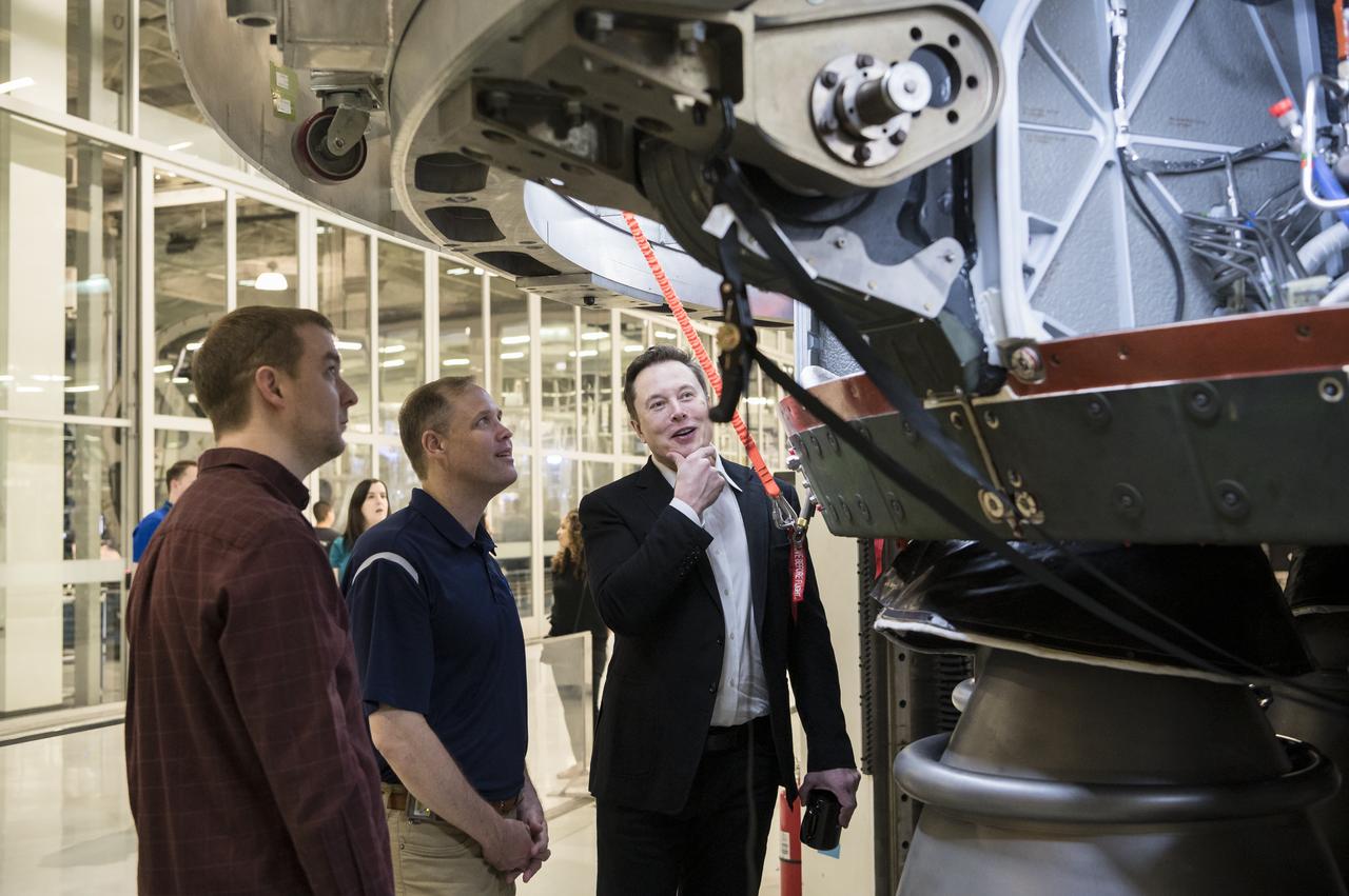 SpaceX Chief Engineer Elon Musk, right, speaks to NASA Administrator Jim Bridenstine, center, and SpaceX Vice President of Propulsion Engineering, Will Heltsley, left, while viewing the OctaWeb, part of the Merlin engine used for the Falcon rockets, at the SpaceX Headquarters, Thursday, Oct. 10, 2019 in Hawthorne, CA. Photo credit: (NASA/Aubrey Gemignani)