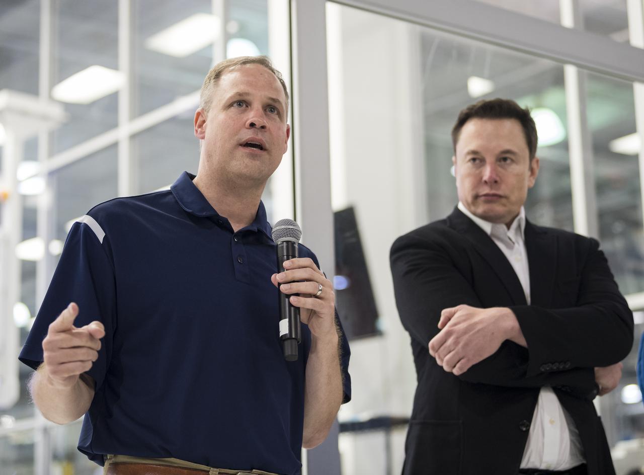 NASA Administrator Jim Bridenstine, left, and SpaceX Chief Engineer Elon Musk, right, speak to press in front of the Crew Dragon that is being prepared for the Demo-2 mission, at SpaceX Headquarters, Thursday, Oct. 10, 2019 in Hawthorne, CA. Photo credit: (NASA/Aubrey Gemignani)