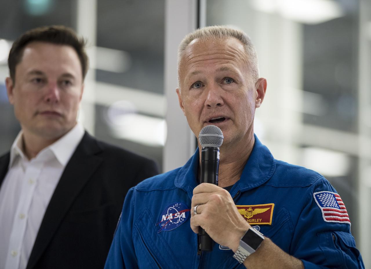 NASA astronaut Doug Hurley answers a question from the media in front of the Crew Dragon that is being prepared for the Demo-2 mission, at SpaceX Headquarters, Thursday, Oct. 10, 2019 in Hawthorne, CA. Hurley and NASA astronaut Bob Behnken are assigned to fly onboard Crew Dragon for the Demo-2 mission. Photo credit: (NASA/Aubrey Gemignani)