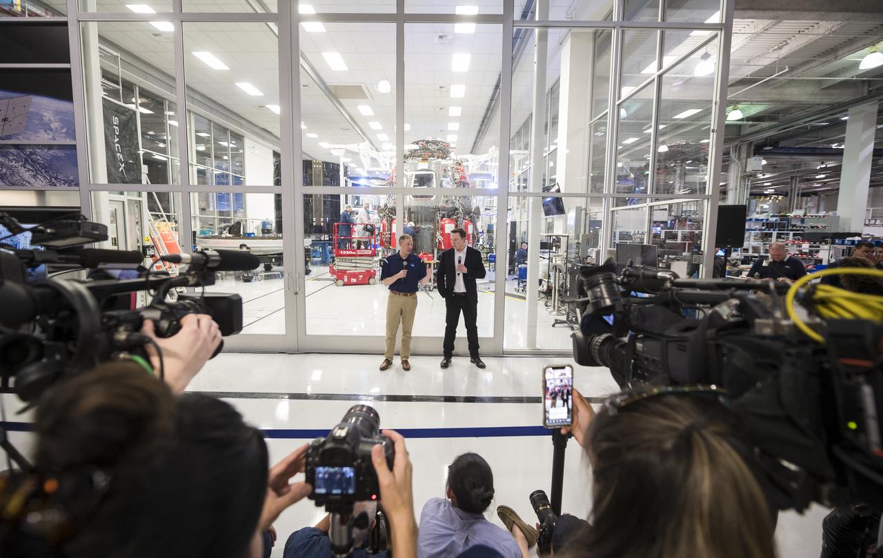 NASA Administrator Jim Bridenstine, left, and SpaceX Chief Engineer Elon Musk, right, speak to press in front of the Crew Dragon that is being prepared for the Demo-2 mission, at SpaceX Headquarters, Thursday, Oct. 10, 2019 in Hawthorne, CA. Photo credit: (NASA/Aubrey Gemignani)