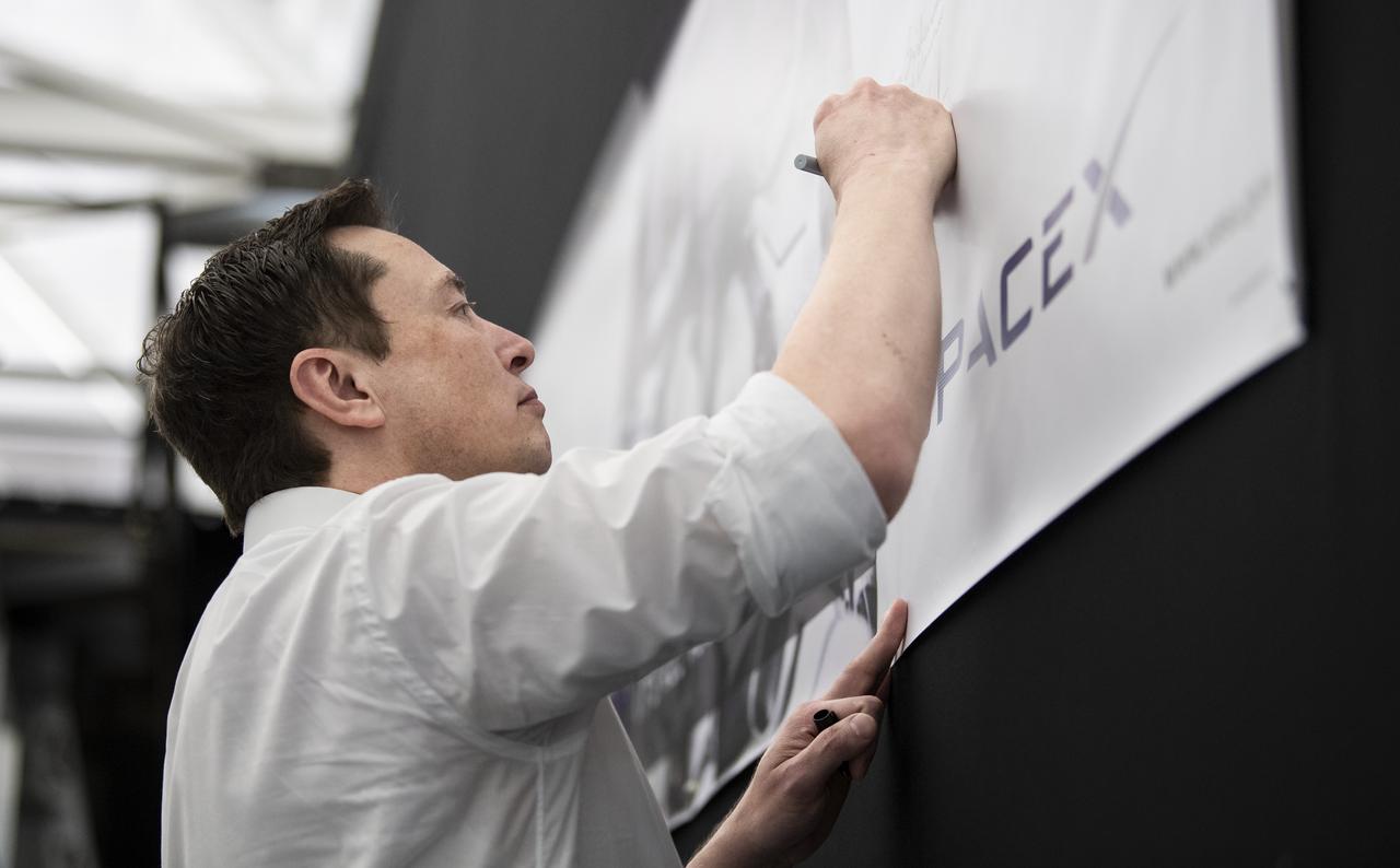 SpaceX Chief Engineer Elon Musk signs a banner after discussing progress on the Commercial Crew Program with NASA Administrator Jim Bridenstine at the SpaceX Headquarters, Thursday, Oct. 10, 2019 in Hawthorne, CA. Photo credit: (NASA/Aubrey Gemignani)