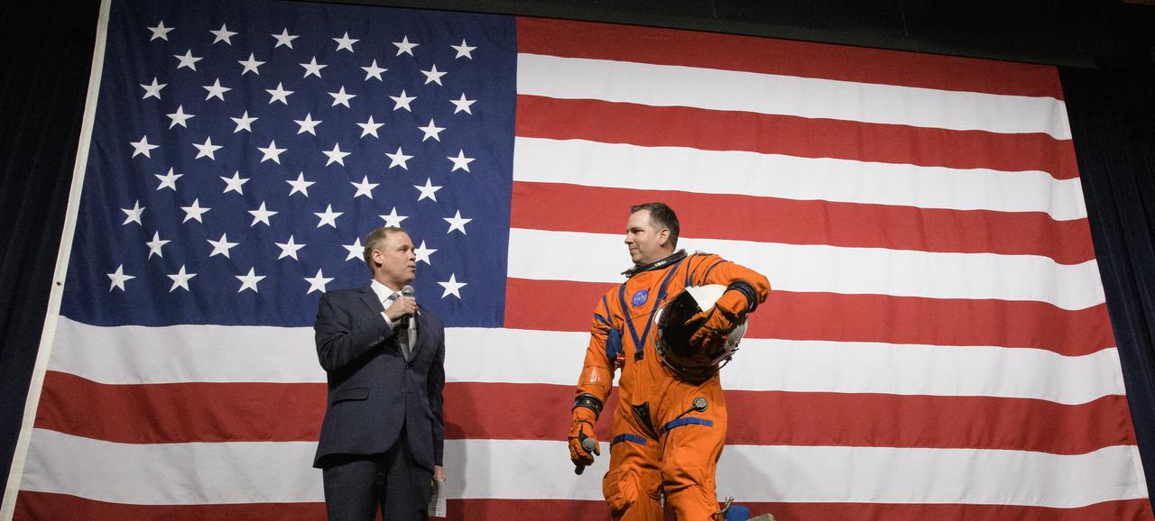 NASA Administrator Jim Bridenstine, left, speaks with Dustin Gohmert, Orion Crew Survival Systems Project Manger at NASA’s Johnson Space Center, wearing the Orion Crew Survival System suit, about the suit, Tuesday, Oct. 15, 2019 at NASA Headquarters in Washington. The Orion suit is designed for a custom fit and incorporates safety technology and mobility features that will help protect astronauts on launch day, in emergency situations, high-risk parts of missions near the Moon, and during the high-speed return to Earth.  Photo Credit: (NASA/Joel Kowsky)