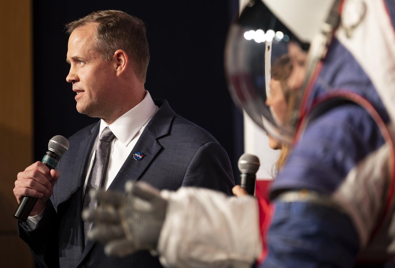 NASA Administrator Jim Bridenstine is seen with Kristine Davis, a spacesuit engineer at NASA’s Johnson Space Center, wearing a ground prototype of NASA’s new Exploration Extravehicular Mobility Unit (xEMU), during a demonstration of the suit, Tuesday, Oct. 15, 2019 at NASA Headquarters in Washington. The xEMU suit improves on the suits previous worn on the Moon during the Apollo era and those currently in use for spacewalks outside the International Space Station and will be worn by first woman and next man as they explore the Moon as part of the agency’s Artemis program.  Photo Credit: (NASA/Joel Kowsky)