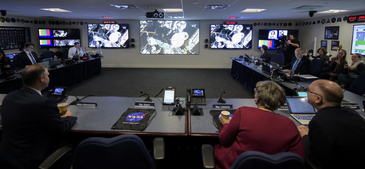 NASA Administrator Jim Bridenstine, NASA management and members of Congess watch the beginning of the first all-woman spacewalk on Friday, Oct. 18, 2019, from the Space Operations Center at NASA Headquarters in Washington. The first all-woman spacewalk in history began at 7:38am EDT with NASA astronauts Christina Koch and Jessica Meir venturing outside the International Space Station to replace a failed battery charge-discharge unit. This is the fourth spacewalk for Koch and Meir’s first. Photo Credit: (NASA/Joel Kowsky)