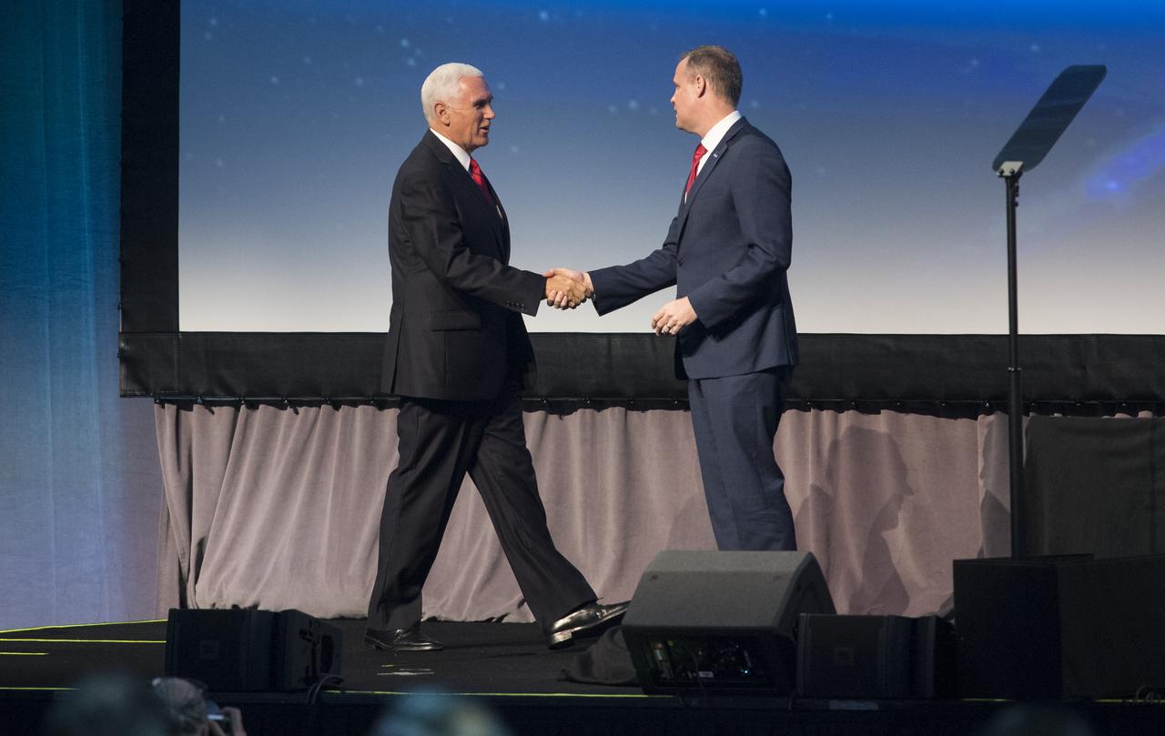 NASA Administrator Jim Bridenstine, right, shakes hands with Vice President Mike Pence after introducing him during the opening ceremony of the 70th International Astronautical Congress, Monday, Oct. 21, 2019 at the Walter E. Washington Convention Center in Washington. Photo Credit: (NASA/Joel Kowsky)