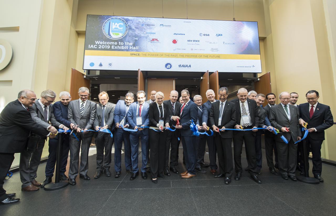NASA Administrator Jim Bridenstine, center in red tie, joins Jean-Yves Le Gall, President of International Astronautical Federation (IAF), and other space agency leaders and dignitaries for the ceremonial ribbon cutting to the exhibit hall at the 70th International Astronautical Congress, Monday, Oct. 21, 2019 at the Walter E. Washington Convention Center in Washington. Photo Credit: (NASA/Bill Ingalls)