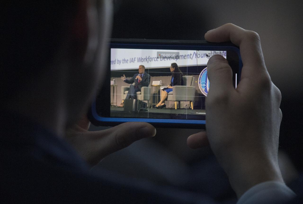 A member of the audience records a video of NASA Administrator Jim Bridenstine and Jackelynne Silva-Martinez, an Aerospace Engineer in Mission Planning Operations at NASA’s Johnson Space Centeris seen during the Global Networking Forum Young Professionals Town Hall at the 70th International Astronautical Congress, Wednesday, Oct. 23, 2019 at the Walter E. Washington Convention Center in Washington. Photo Credit: (NASA/Joel Kowsky)
