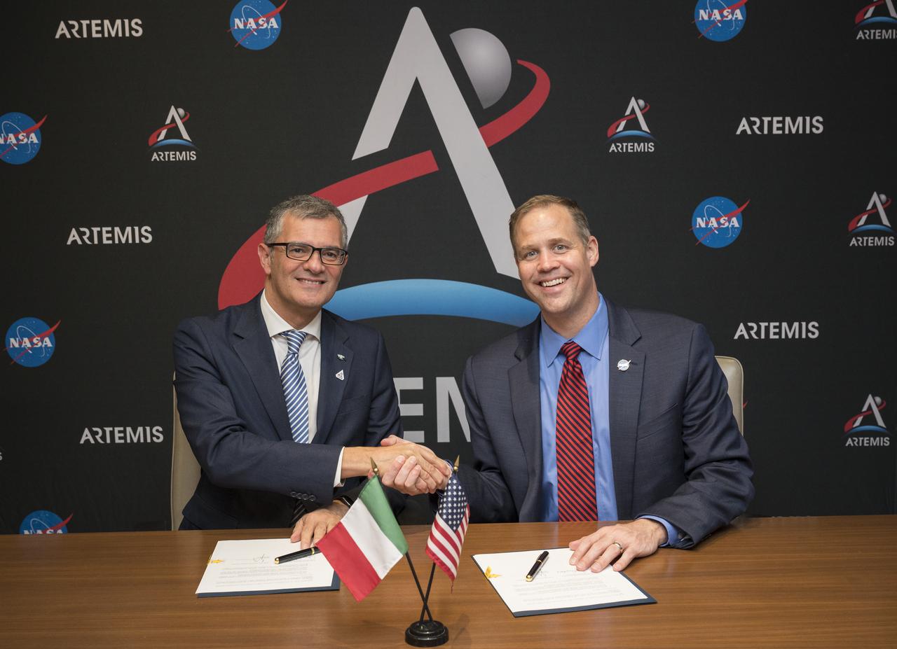 Giorgio Saccoccia Head of the Italian Space Agency (ASI), left, and NASA Administrator Jim Bridenstine shake hands after signing a joint statement acknowledging the strong ongoing cooperation between the agencies, and identifying areas of potential future cooperation on and around the Moon as part of NASA’s Artemis program at the 70th International Astronautical Congress, Wednesday, Oct. 23, 2019 in Washington. Photo Credit: (NASA/Joel Kowsky)