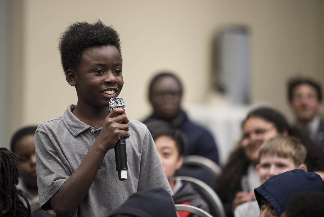 A student asks a panel of NASA astronauts including Doug Wheelock, Alvin Drew, Jeanette Epps, and former astronauts Janet Kavandi, and Bob Curbeam, a question about their time in space at a STEM day session during the 70th International Astronautical Congress, Wednesday, Oct. 23, 2019 at the Walter E. Washington Convention Center in Washington. Photo credit: (NASA/Aubrey Gemignani)