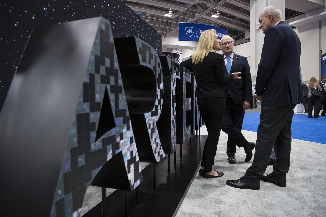 Philippe Étienne, French Ambassador to the U.S., center, and Jean-Yves Le Gall, president of the French space agency, National Centre for Space Studies (CNES), right, are seen talking to NASA Chief of Staff Janet Karika at the NASA exhibit during the 70th International Astronautical Congress, Wednesday, Oct. 23, 2019, at the Walter E. Washington Convention Center in Washington. Photo credit: (NASA/Aubrey Gemignani)