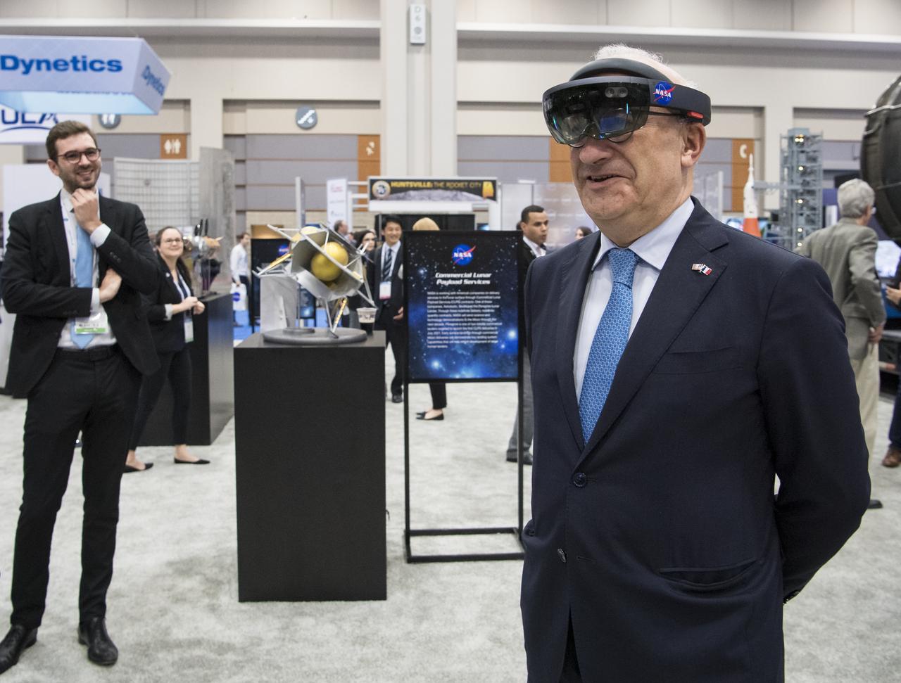 Philippe Étienne, French Ambassador to the U.S., tries virtual reality viewers at the NASA exhibit during the 70th International Astronautical Congress, Wednesday, Oct. 23, 2019, at the Walter E. Washington Convention Center in Washington. Photo credit: (NASA/Aubrey Gemignani)