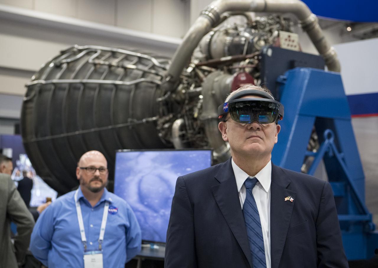 Jean-Yves Le Gall, president of the French space agency, National Centre for Space Studies (CNES), tries virtual reality viewers at the NASA exhibit during the 70th International Astronautical Congress, Wednesday, Oct. 23, 2019, at the Walter E. Washington Convention Center in Washington. Photo credit: (NASA/Aubrey Gemignani)