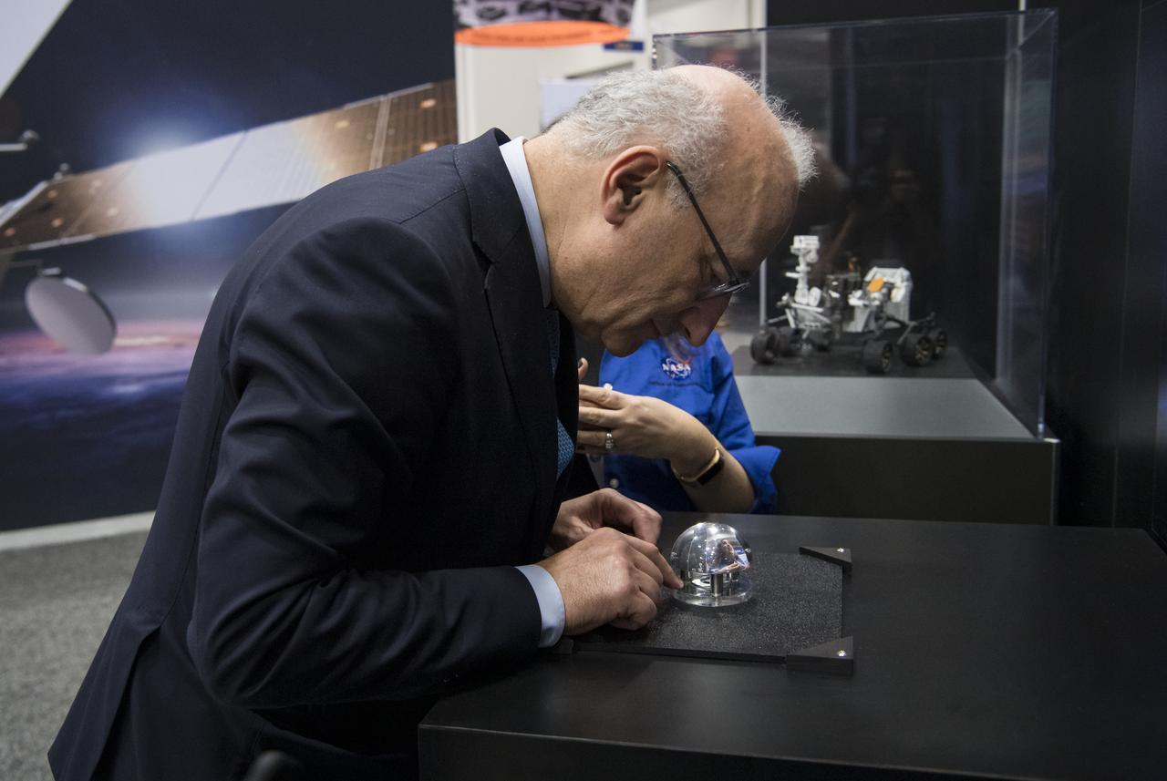 Philippe Étienne, French Ambassador to the U.S. touches a Mars meteorite at the NASA exhibit during the 70th International Astronautical Congress, Wednesday, Oct. 23, 2019, at the Walter E. Washington Convention Center in Washington. Photo credit: (NASA/Aubrey Gemignani)