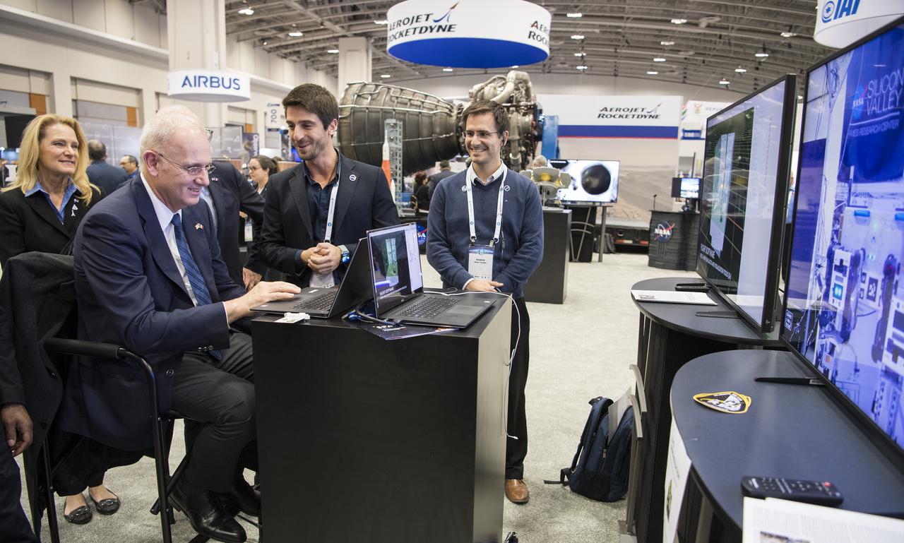 Jean-Yves Le Gall, president of the French space agency, National Centre for Space Studies (CNES), tests a robotic arm at the NASA exhibit during the 70th International Astronautical Congress, Wednesday, Oct. 23, 2019, at the Walter E. Washington Convention Center in Washington. Photo credit: (NASA/Aubrey Gemignani)