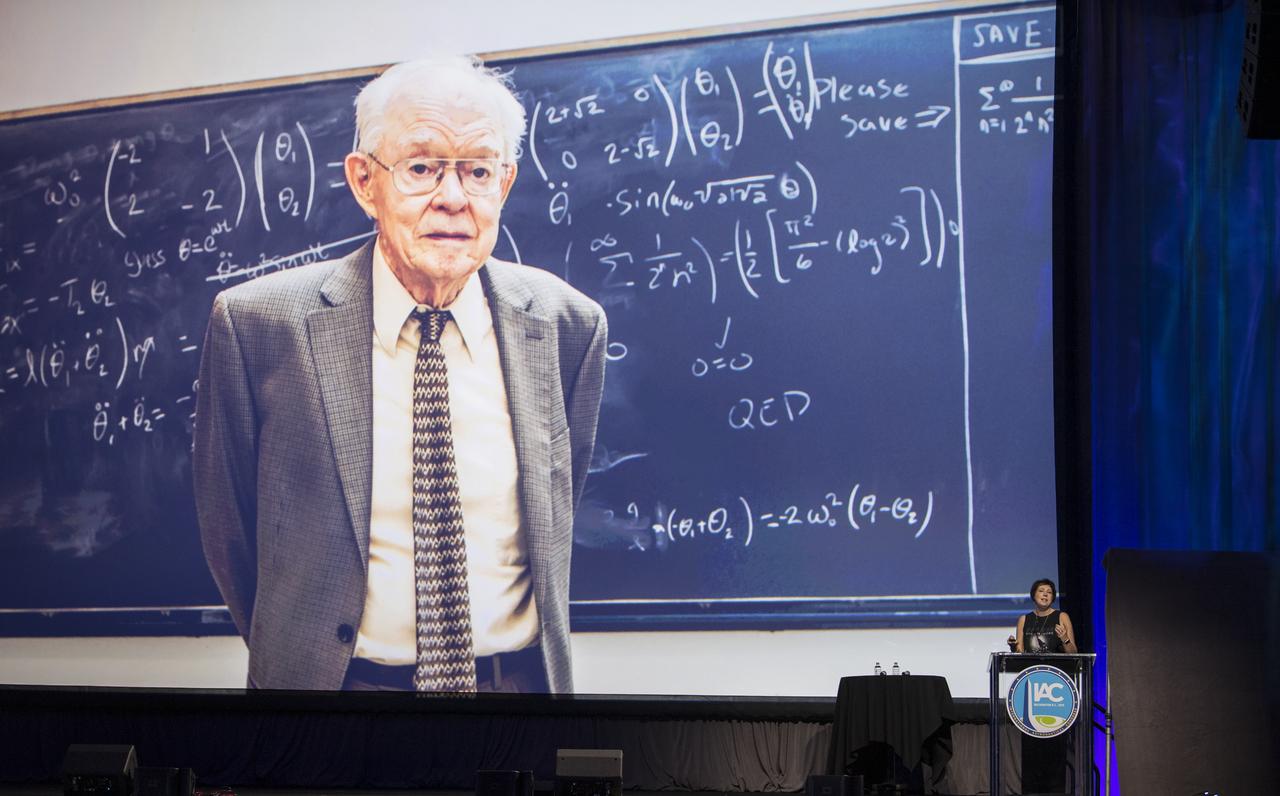 NASA director of Heliophysics division, Science Mission Directorate, Nicola Fox, shows a photo of Eugene Parker, the physicist who first predicted there was solar wind, during a presentation titled, “The Challenge of Exploring Our Sun - the 60-Year Odyssey to Parker Solar Probe,” during the 70th International Astronautical Congress, Wednesday, Oct. 23, 2019, at the Walter E. Washington Convention Center in Washington. Photo credit: (NASA/Aubrey Gemignani)