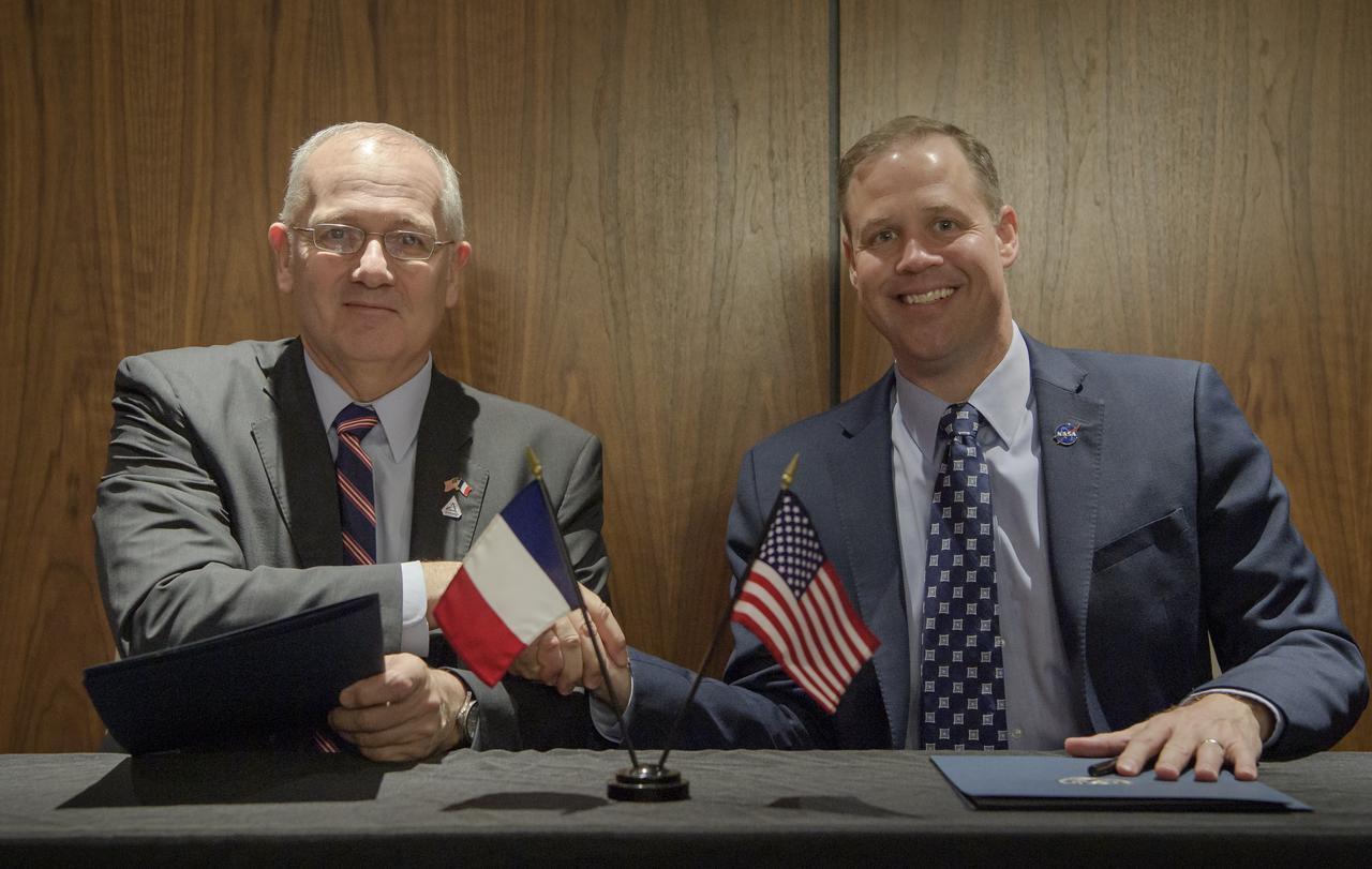 Jean-Yves Le Gall, President of the Centre National d’Études Spatiales (CNES), left, shakes hands with NASA Administrator Jim Bridenstine after signing an amendment to the Surface Water and Ocean Topography Mission agreement at the 70th International Astronautical Congress, Thursday, Oct. 24, 2019, in Washington. Photo Credit: (NASA/Bill Ingalls)