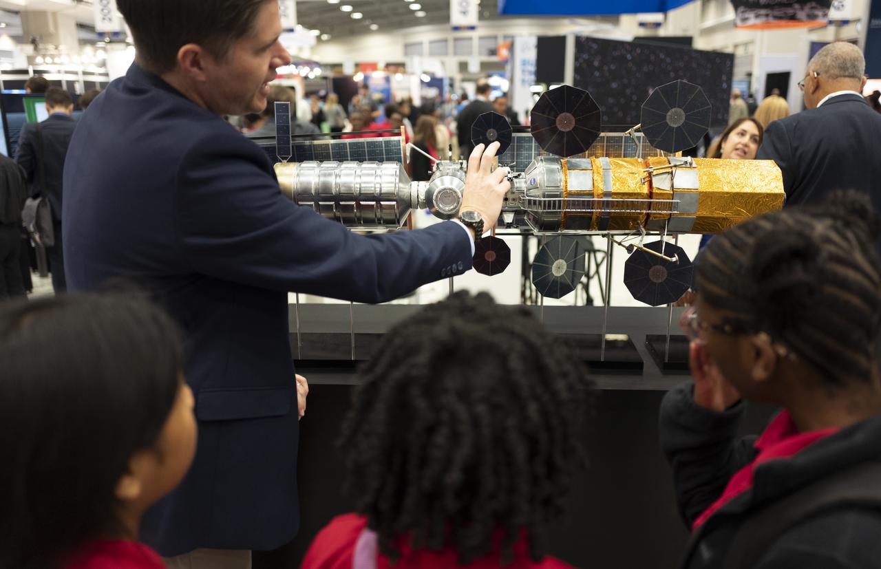 Local students view a model of NASA’s Gateway spacecraft while visiting the NASA exhibit at the 70th International Astronautical Congress, Thursday, Oct. 24, 2019, in Washington. Photo Credit: (NASA/Joel Kowsky)