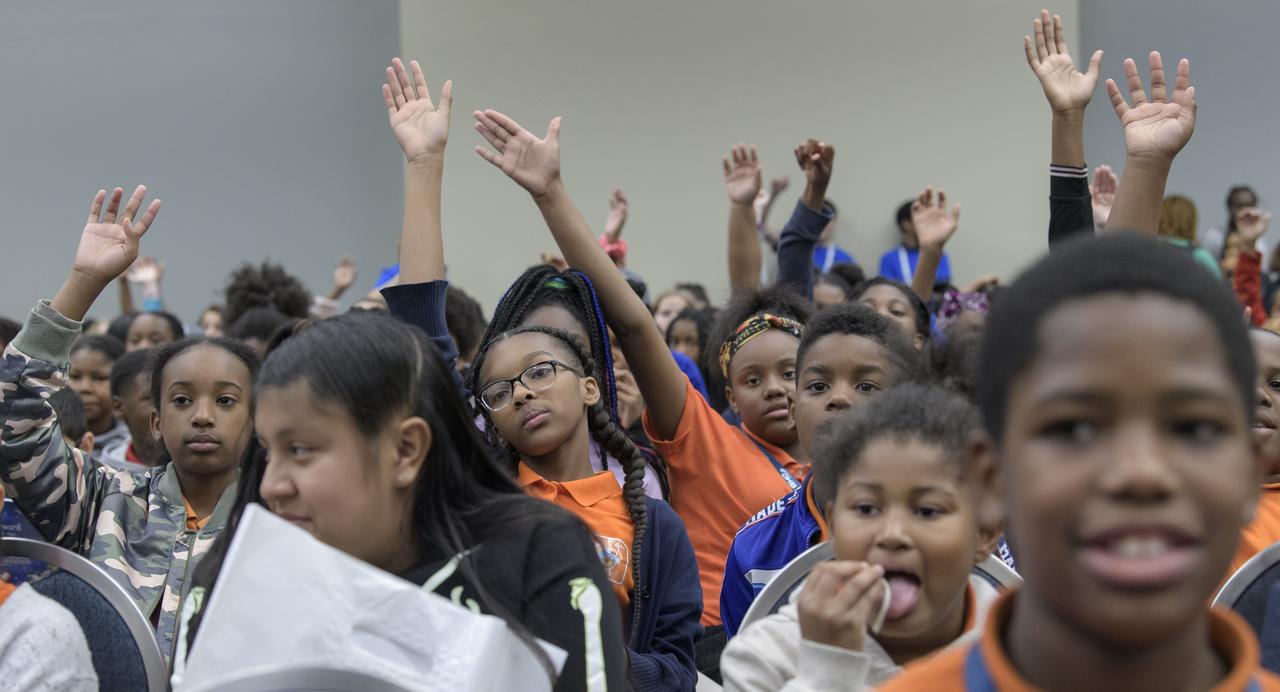 Students raise their hands to ask a question during a STEM day session at the 70th International Astronautical Congress, Thursday, Oct. 24, 2019, in Washington. Photo Credit: (NASA/Bill Ingalls)