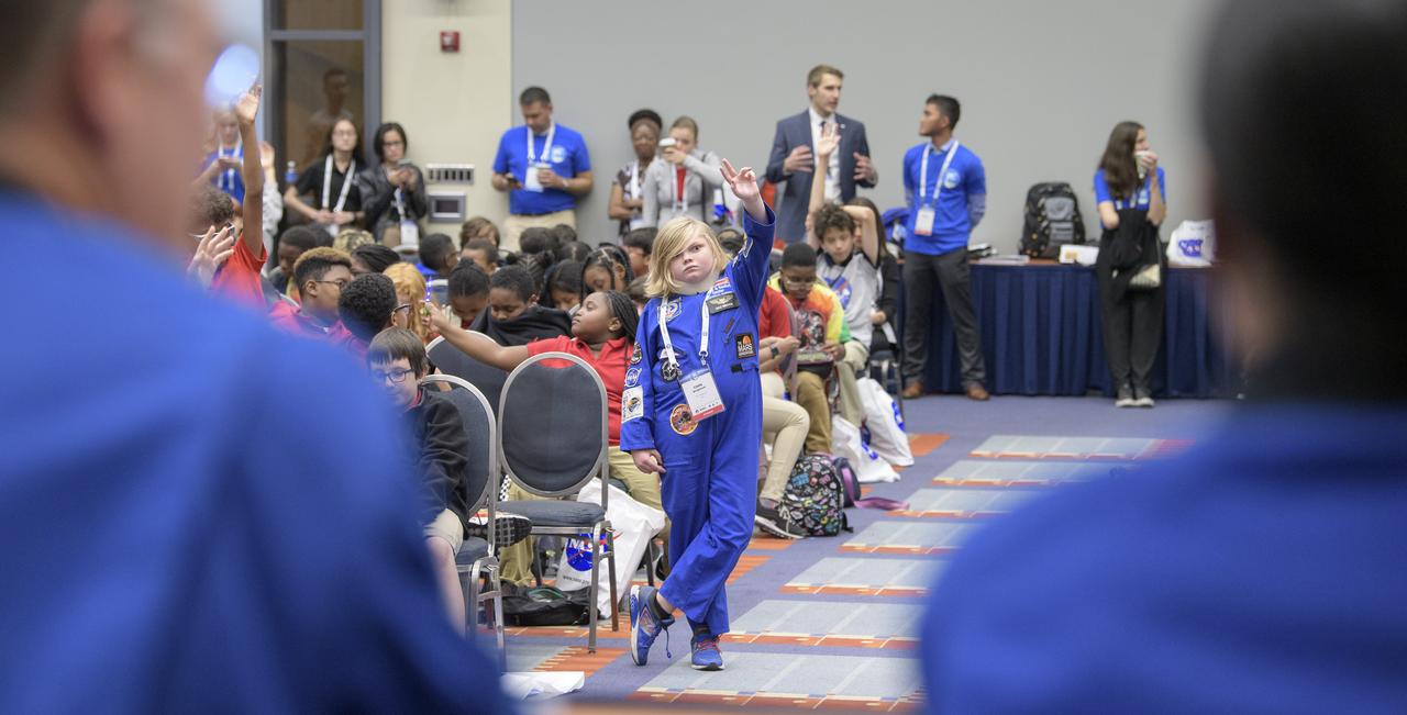 Students raise their hands to ask a question during a STEM day session at the 70th International Astronautical Congress, Thursday, Oct. 24, 2019, in Washington. Photo Credit: (NASA/Bill Ingalls)