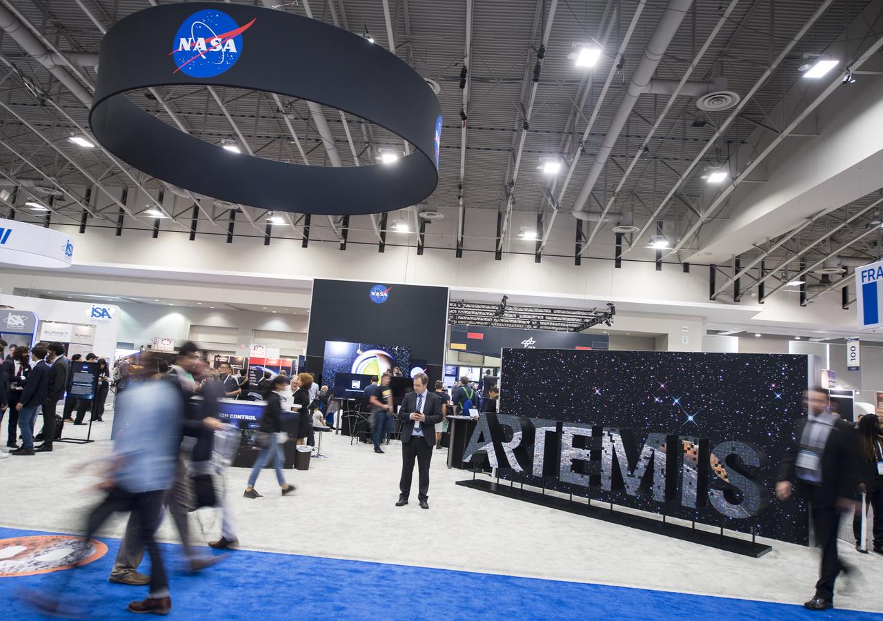 Attendees are seen by the NASA exhibit at the 70th International Astronautical Congress, Friday, Oct. 25, 2019, at the Walter E. Washington Convention Center in Washington.  Photo Credit: (NASA/Joel Kowsky)