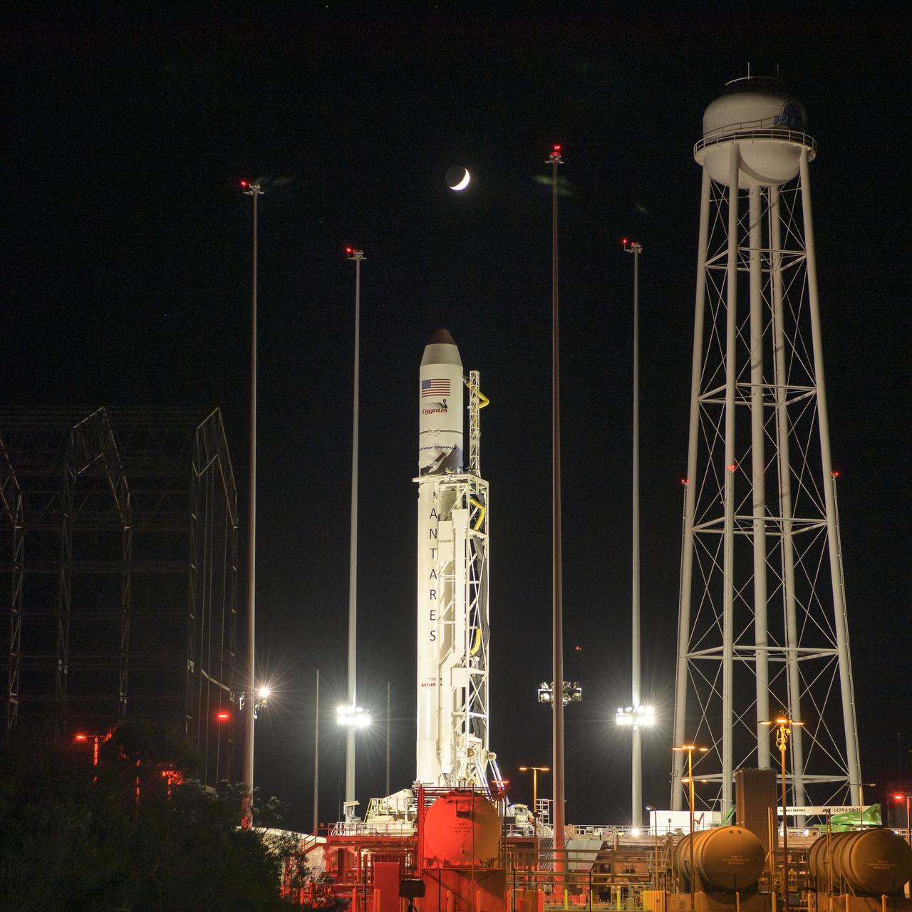 The crescent Moon is seen above the Northrop Grumman Antares rocket at launch Pad-0A, Friday, Nov. 1, 2019, at NASA's Wallops Flight Facility in Virginia. Northrop Grumman’s 12th contracted cargo resupply mission with NASA to the International Space Station will deliver about 8,200 pounds of science and research, crew supplies and vehicle hardware to the orbital laboratory and its crew. Launch is scheduled for 9:59 a.m. EDT Saturday, Nov. 2.  Photo Credit: (NASA/Bill Ingalls)