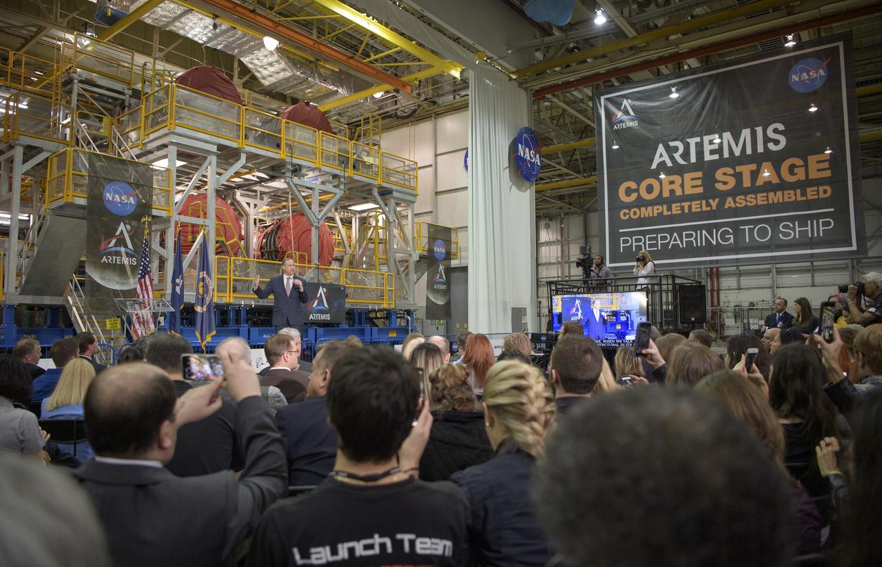 NASA Administrator Jim Bridenstine gives remarks on the agency’s Artemis program, Monday, Dec. 9, 2019, in front of the core stage for NASA’s Space Launch System (SLS) rocket at NASA’s Michoud Assembly Facility in New Orleans. Through Artemis NASA will land the first woman and next man on the Moon by 2024. Photo Credit: (NASA/Bill Ingalls)