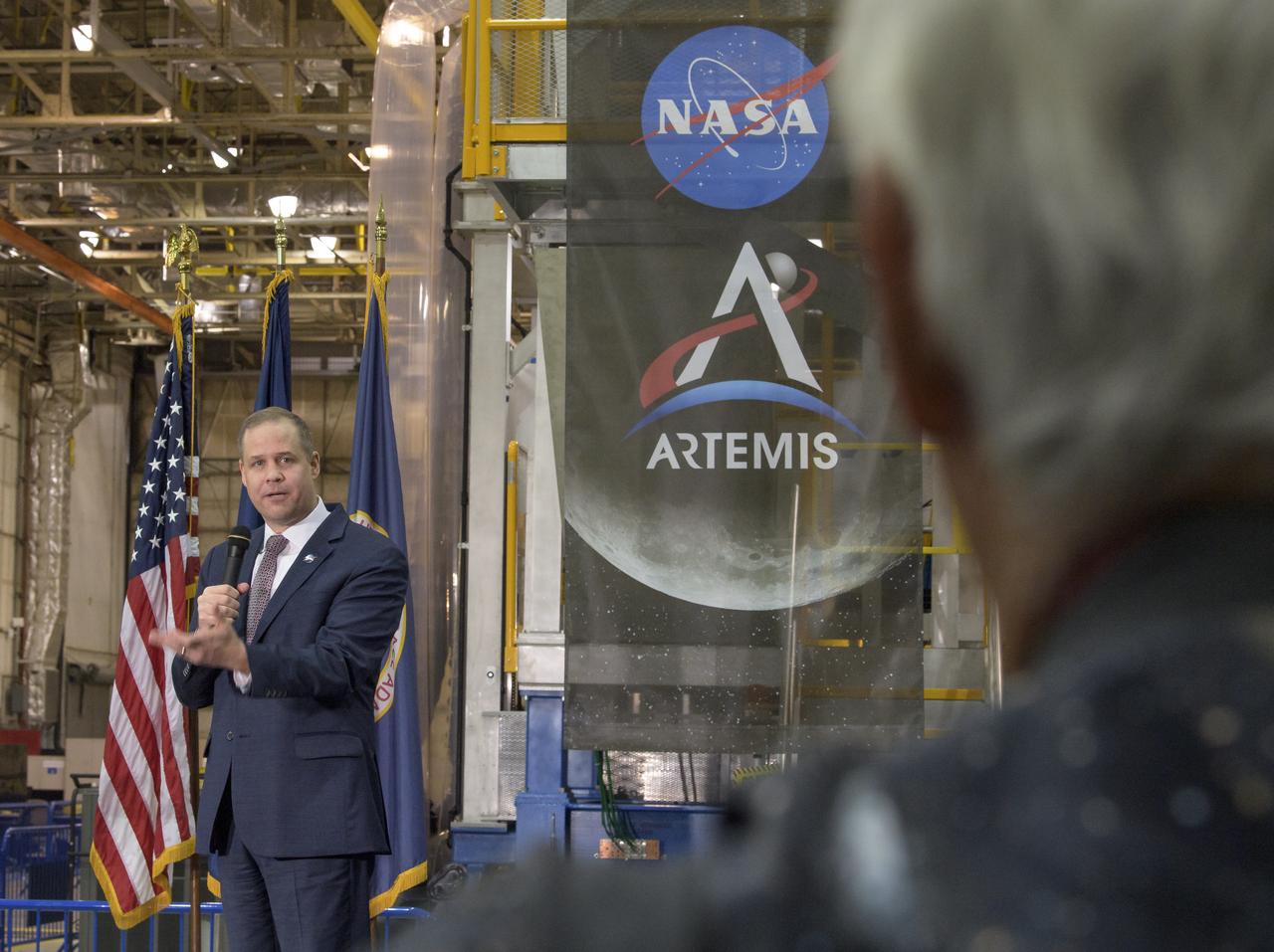 NASA Administrator Jim Bridenstine gives remarks on the agency’s Artemis program, Monday, Dec. 9, 2019, in front of the core stage for NASA’s Space Launch System (SLS) rocket at NASA’s Michoud Assembly Facility in New Orleans. Through Artemis NASA will land the first woman and next man on the Moon by 2024. Photo Credit: (NASA/Bill Ingalls)