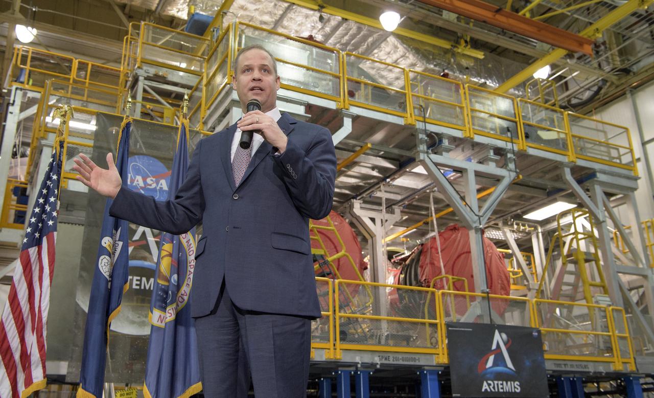 NASA Administrator Jim Bridenstine gives remarks on the agency’s Artemis program, Monday, Dec. 9, 2019, in front of the core stage for NASA’s Space Launch System (SLS) rocket at NASA’s Michoud Assembly Facility in New Orleans. Through Artemis NASA will land the first woman and next man on the Moon by 2024. Photo Credit: (NASA/Bill Ingalls)