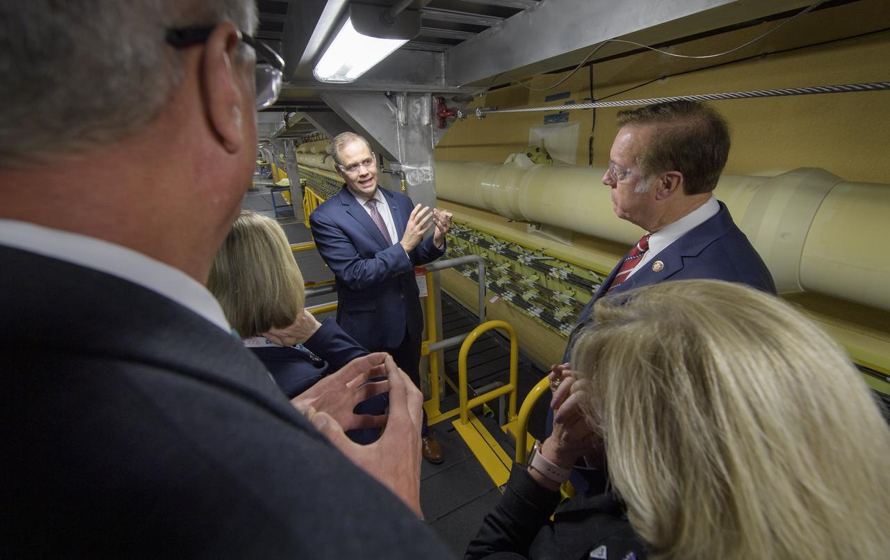 NASA Administrator Jim Bridenstine, left, along with U.S. Representative Randy Weber (R-TX), right, and other NASA and Boeing management view the core stage for NASA’s Space Launch System (SLS) rocket that will help power the first Artemis mission to the Moon, Monday, Dec. 9, 2019, at NASA’s Michoud Assembly Facility in New Orleans. Through Artemis NASA will land the first woman and next man on the Moon by 2024. Photo Credit: (NASA/Bill Ingalls)