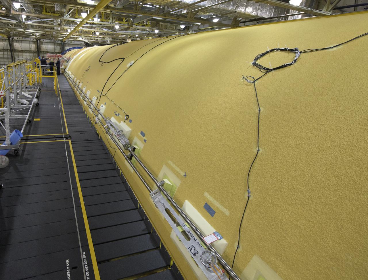 NASA Administrator Jim Bridenstine, NASA Marshall Space Flight Center Director Jody Singer, NASA Marshall Space Flight Center Deputy Program manager, Space Launch System Program, Chris Cianciola, Boeing Director of operations at Michoud Assembly Facility Jennifer Boland-Masterson, U.S. Representative Randy Weber (R-TX), and Dayne Cutrell, Chief of Staff for Alabama Senator Richard Shelby, background, view the core stage for NASA’s Space Launch System (SLS) rocket that will help power the first Artemis mission to the Moon, Monday, Dec. 9, 2019, at NASA’s Michoud Assembly Facility in New Orleans. Through Artemis NASA will land the first woman and next man on the Moon by 2024. Photo Credit: (NASA/Bill Ingalls)