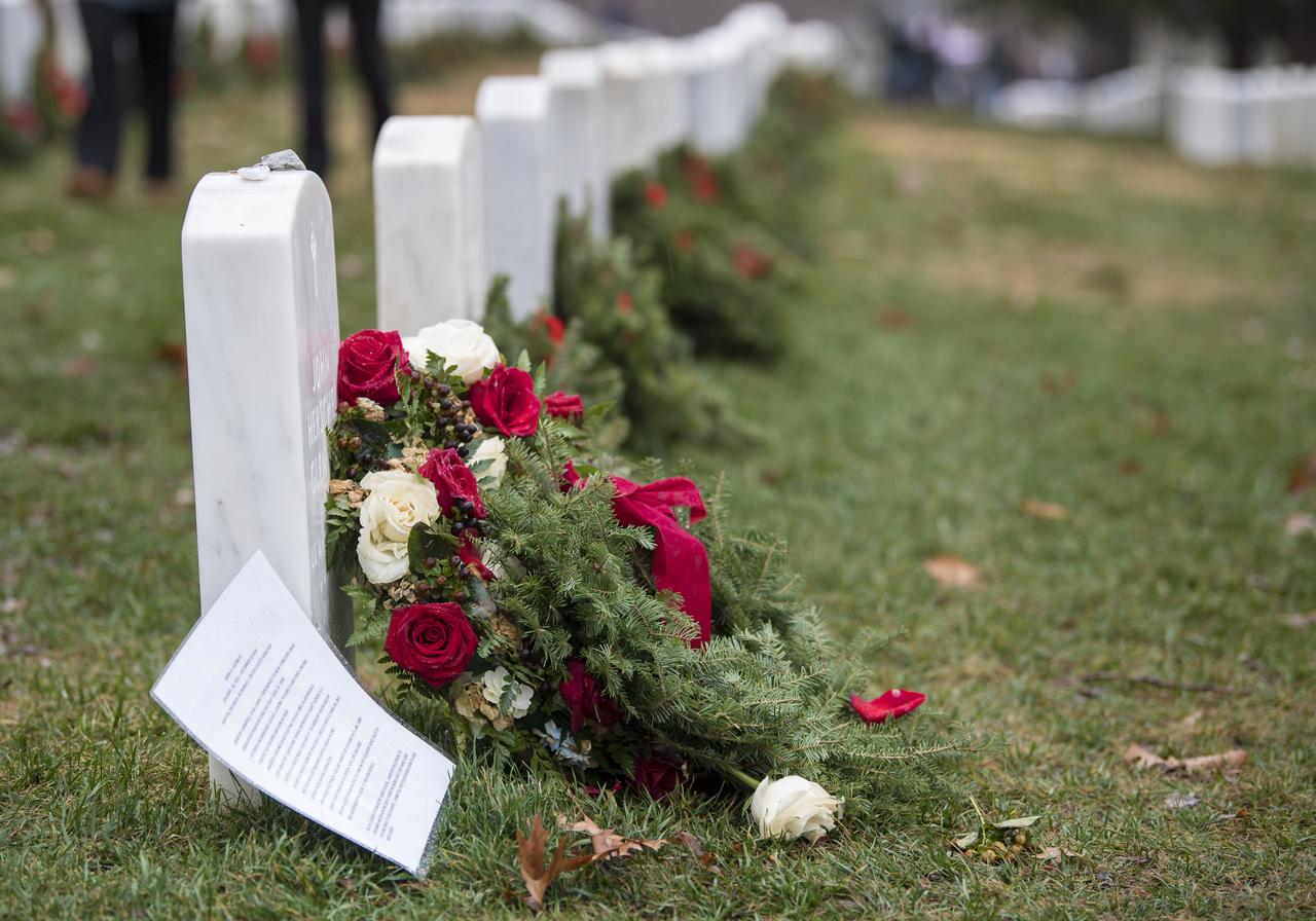 The headstone of former astronaut and U.S. Senator John Glenn is seen on National Wreaths Across America Day at Arlington National Cemetery, Sat., Dec. 14, 2019 in Arlington, Va. National Wreaths Across America Day is held annually to celebrate the lives of military veterans. NASA astronaut Doug Wheelock attended to honor those who lost their lives in the quest for space exploration as well as fellow service members.  Photo Credit: (NASA/Aubrey Gemignani)