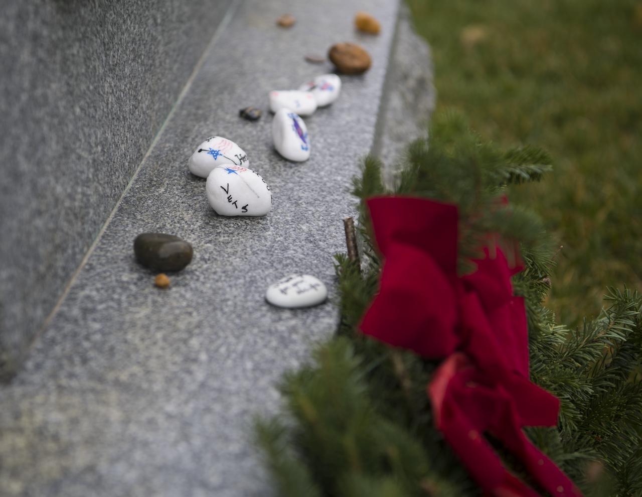 Items are seen at the Space Shuttle Challenger memorial on National Wreaths Across America Day at Arlington National Cemetery, Sat., Dec. 14, 2019 in Arlington, Va. National Wreaths Across America Day is held annually to celebrate the lives of military veterans. NASA astronaut Doug Wheelock attended to honor those who lost their lives in the quest for space exploration as well as fellow service members.  Photo Credit: (NASA/Aubrey Gemignani)