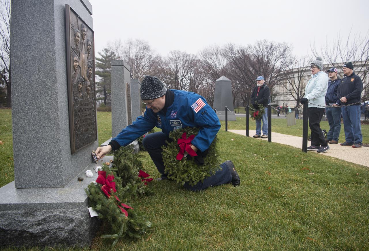 NASA astronaut Doug Wheelock leaves his STS-120 mission patch at the memorial for the Space Shuttle Challenger crew during National Wreaths Across America Day at Arlington National Cemetery, Sat., Dec. 14, 2019 in Arlington, Va. National Wreaths Across America Day is held annually to celebrate the lives of military veterans and wreaths are placed at the foot of every headstone. Wheelock honored those who lost their lives in the quest for space exploration as well as fellow service members. Photo Credit: (NASA/Aubrey Gemignani)