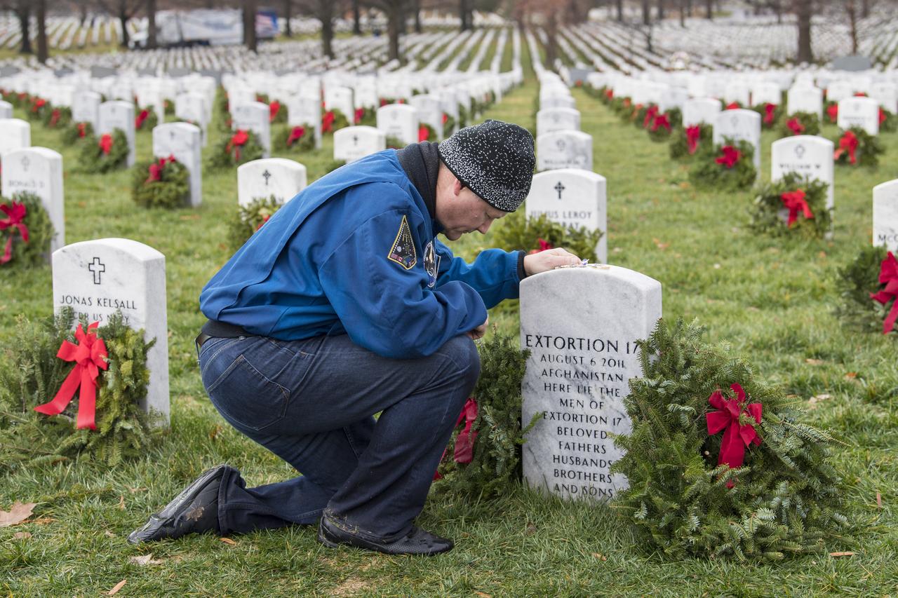 NASA astronaut Doug Wheelock takes a moment after laying a wreath at the headstone of the Extortion 17, fellow service members who lost their lives during his tour of duty in Afghanistan, as part of National Wreaths Across America Day, Sat., Dec. 14, 2019 at Arlington National Cemetery in Arlington, Va. National Wreaths Across America Day is held annually to celebrate the lives of military veterans. Wheelock honored those who lost their lives in the quest for space exploration as well as fellow service members. Photo Credit: (NASA/Aubrey Gemignani)