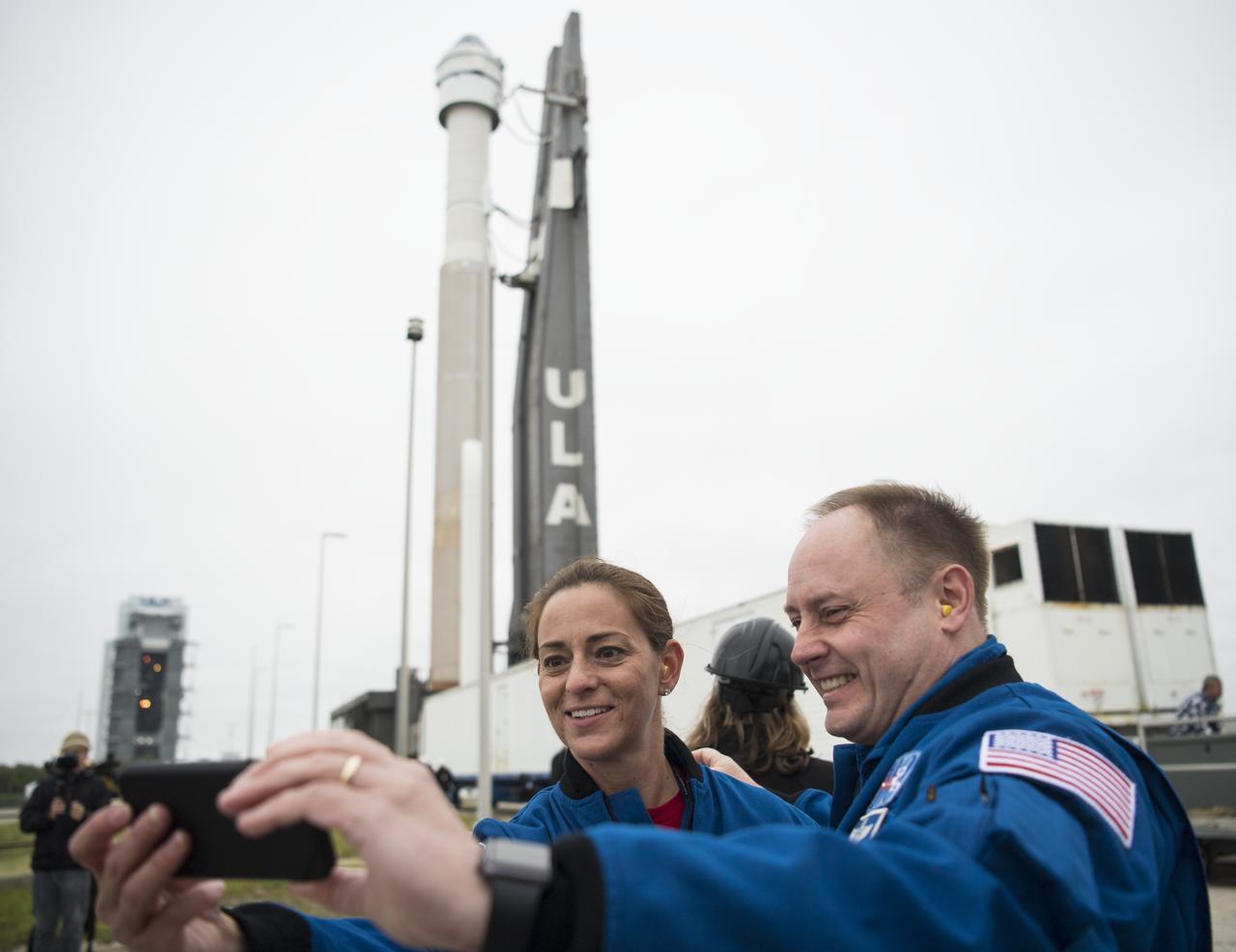 NASA astronauts Nicole Mann, left, and Michael Fincke take a selfie as a United Launch Alliance Atlas V rocket with Boeing’s CST-100 Starliner spacecraft onboard is seen as it is rollout out of the Vertical Integration Facility to the launch pad at Space Launch Complex 41 ahead of the Orbital Flight Test mission, Wednesday, Dec. 18, 2019 at Cape Canaveral Air Force Station in Florida. Mann, Fincke, and Boeing astronaut Chris Ferguson are assigned to fly onboard Starliner for the Crew Flight Test. The uncrewed Orbital Flight Test will be Starliner’s maiden mission to the International Space Station for NASA's Commercial Crew Program. The mission, currently targeted for a 6:26 a.m. EST launch on Dec. 20, will serve as an end-to-end test of the system's capabilities. Photo Credit: (NASA/Joel Kowsky)
