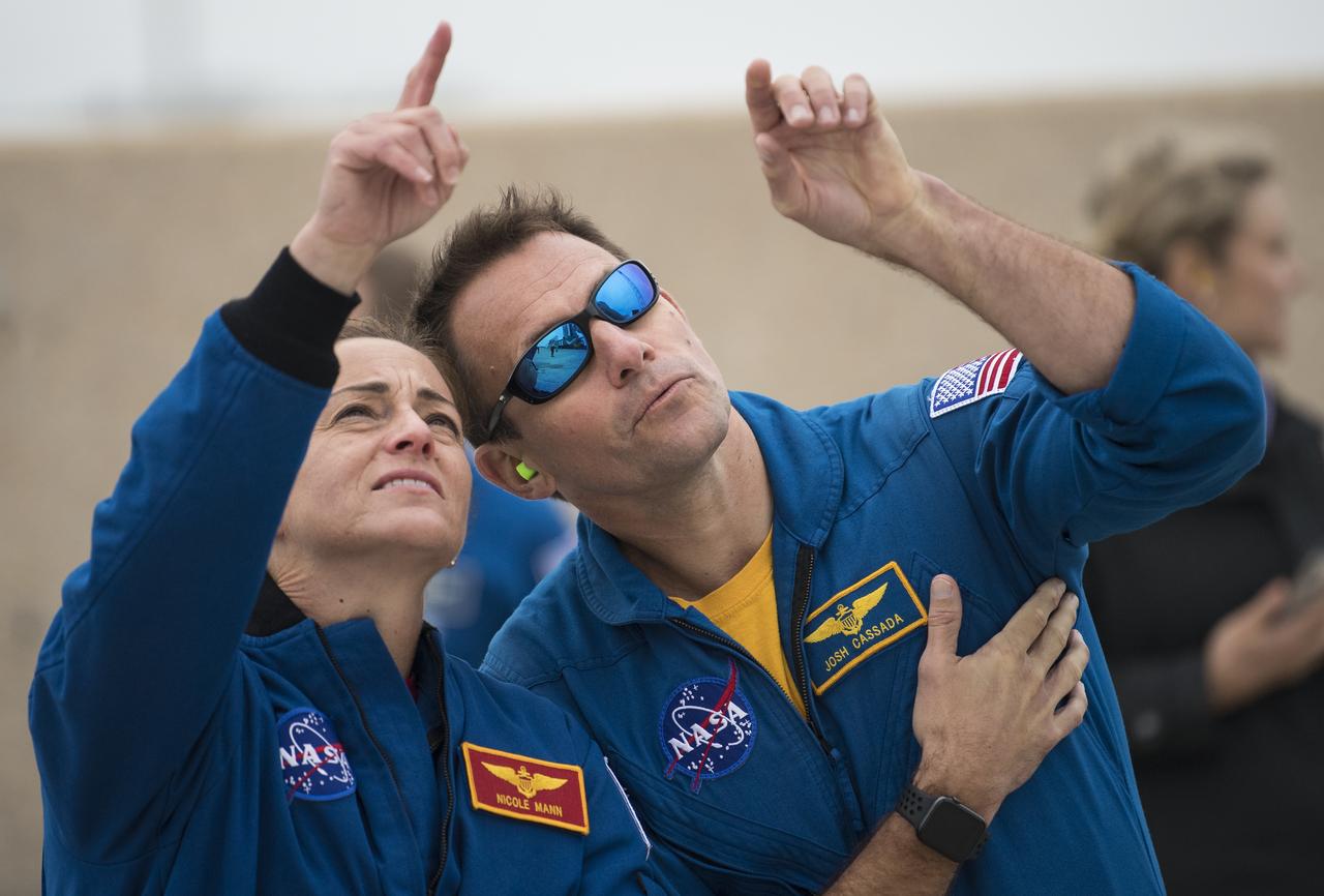 NASA astronauts Nicole Mann and Josh Cassada watch as a United Launch Alliance Atlas V rocket with Boeing’s CST-100 Starliner spacecraft onboard is rolled to the launch pad at Space Launch Complex 41 ahead of the Orbital Flight Test mission, Wednesday, Dec. 18, 2019 at Cape Canaveral Air Force Station in Florida. The uncrewed Orbital Flight Test with be Starliner’s maiden mission to the International Space Station for NASA's Commercial Crew Program. The mission, currently targeted for a 6:26 a.m. EST launch on Dec. 20, will serve as an end-to-end test of the system's capabilities. Photo Credit: (NASA/Joel Kowsky)