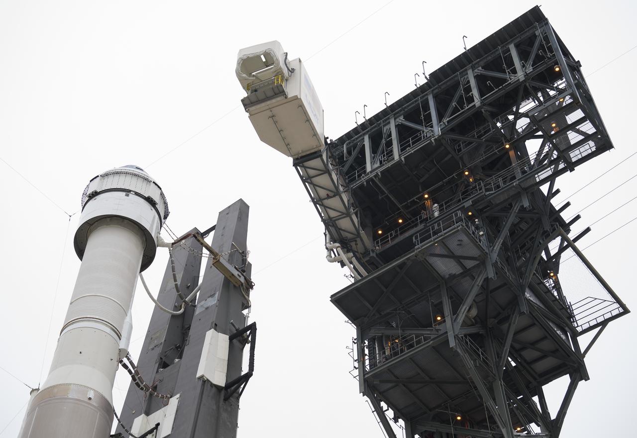 The crew access arm is seen as it swings into position for Boeing’s CST-100 Starliner spacecraft atop a United Launch Alliance Atlas V rocket on the launch pad at Space Launch Complex 41 ahead of the Orbital Flight Test mission, Wednesday, Dec. 18, 2019 at Cape Canaveral Air Force Station in Florida. The uncrewed Orbital Flight Test will be Starliner’s maiden mission to the International Space Station for NASA's Commercial Crew Program. The mission, currently targeted for a 6:26 a.m. EST launch on Dec. 20, will serve as an end-to-end test of the system's capabilities. Photo Credit: (NASA/Joel Kowsky)