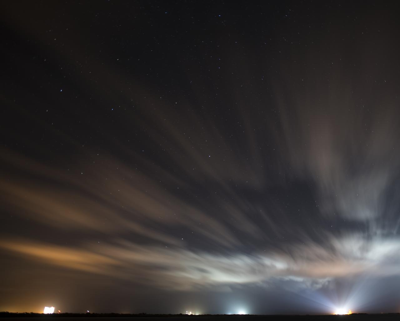 In this long exposure image, Space Launch Complex 41 at Cape Canaveral Air Force Station, right, is seen illuminated by spotlights ahead of Boeing's CST-100 Starliner Orbital Flight Test mission, Wednesday, Dec. 18, 2019, at Cape Canaveral Air Force Station in Florida. Also visible are the Vehicle Assembly Building, left, and Launch Pad’s 39B, second from left, and 39A, second from right at NASA’s Kennedy Space Center. The uncrewed Orbital Flight Test, launching onboard a United Launch Alliance Atlas V rocket, will be Starliner’s maiden mission to the International Space Station for NASA's Commercial Crew Program. The mission, currently targeted for a 6:26 a.m. EST launch on Dec. 20, will serve as an end-to-end test of the system's capabilities. Photo Credit: (NASA/Joel Kowsky)