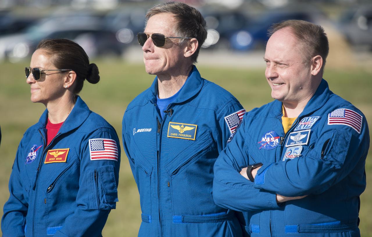 NASA astronauts Nicole Mann, left, and Michael Fincke, right, and Boeing astronaut Chris Ferguson, center, who are assigned to fly on Boeing’s Crew Flight Test, are seen during a press conference ahead of the Boeing Orbital Flight Test mission, Thursday, Dec. 19, 2019 at NASA’s Kennedy Space Center in Florida. The uncrewed Orbital Flight Test will be Starliner’s maiden mission to the International Space Station for NASA's Commercial Crew Program. The mission, currently targeted for a 6:36 a.m. EST launch on Dec. 20, will serve as an end-to-end test of the system's capabilities. Photo Credit: (NASA/Joel Kowsky)