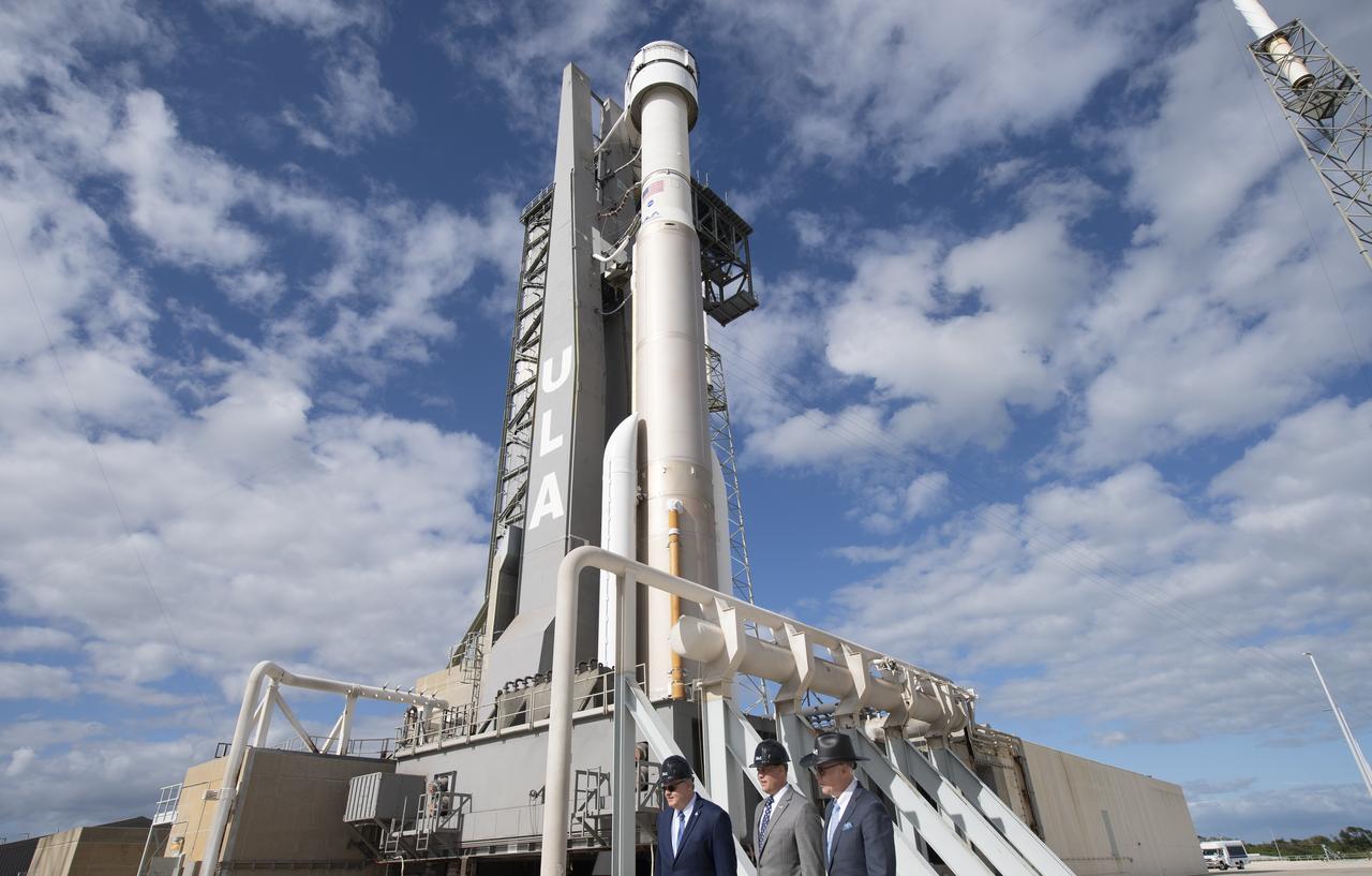 Jim Chilton, senior vice president for Boeing Space and Launch, left, NASA Administrator Jim Bridenstine, and Tory Bruno, president and CEO of United Launch Alliance are seen walking past a United Launch Alliance Atlas V rocket with Boeing’s CST-100 Starliner spacecraft onboard on the launch pad at Space Launch Complex 41 ahead of the Orbital Flight Test mission, Thursday, Dec. 19, 2019, at Cape Canaveral Air Force Station in Florida. The uncrewed Orbital Flight Test will be Starliner’s maiden mission to the International Space Station for NASA's Commercial Crew Program. The mission, currently targeted for a 6:36 a.m. EST launch on Dec. 20, will serve as an end-to-end test of the system's capabilities. Photo Credit: (NASA/Joel Kowsky)