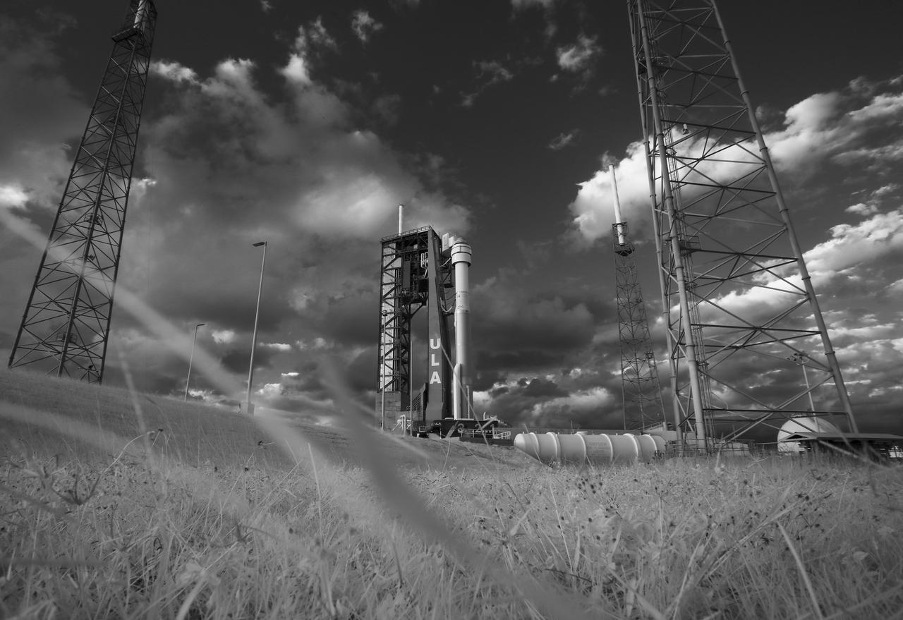 In this black and white infrared image, a United Launch Alliance Atlas V rocket with Boeing’s CST-100 Starliner spacecraft onboard is seen on the launch pad at Space Launch Complex 41 ahead of the Orbital Flight Test mission, Thursday, Dec. 19, 2019, at Cape Canaveral Air Force Station in Florida. After a successful launch at 6:36 a.m. EST on Dec. 20, Boeing’s CST-100 Starliner is in an unplanned, but stable orbit. The team is assessing what test objectives can be achieved before the spacecraft’s return to land in White Sands, New Mexico. Photo Credit: (NASA/Joel Kowsky)