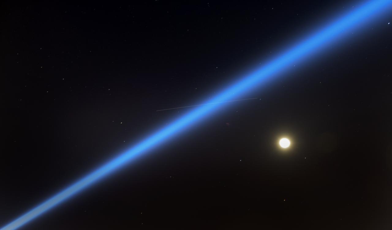 The International Space Station, a search light, and the Moon are seen in this long exposure photograph as teams from Boeing, NASA, and U.S. Army personnel prepare for the Boeing CST-100 Starliner spacecraft landing in White Sands, New Mexico, Sunday, Dec. 22, 2019. The landing will complete an abbreviated Orbital Flight Test for the company that still meets several mission objectives for NASA’s Commercial Crew program. The Starliner spacecraft launched on a United Launch Alliance Atlas V rocket at 6:36 a.m. Friday, Dec. 20 from Space Launch Complex 41 at Cape Canaveral Air Force Station in Florida. Photo Credit: (NASA/Bill Ingalls)